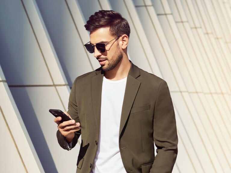 A man visiting the Mercedes me Store on his mobile phone.