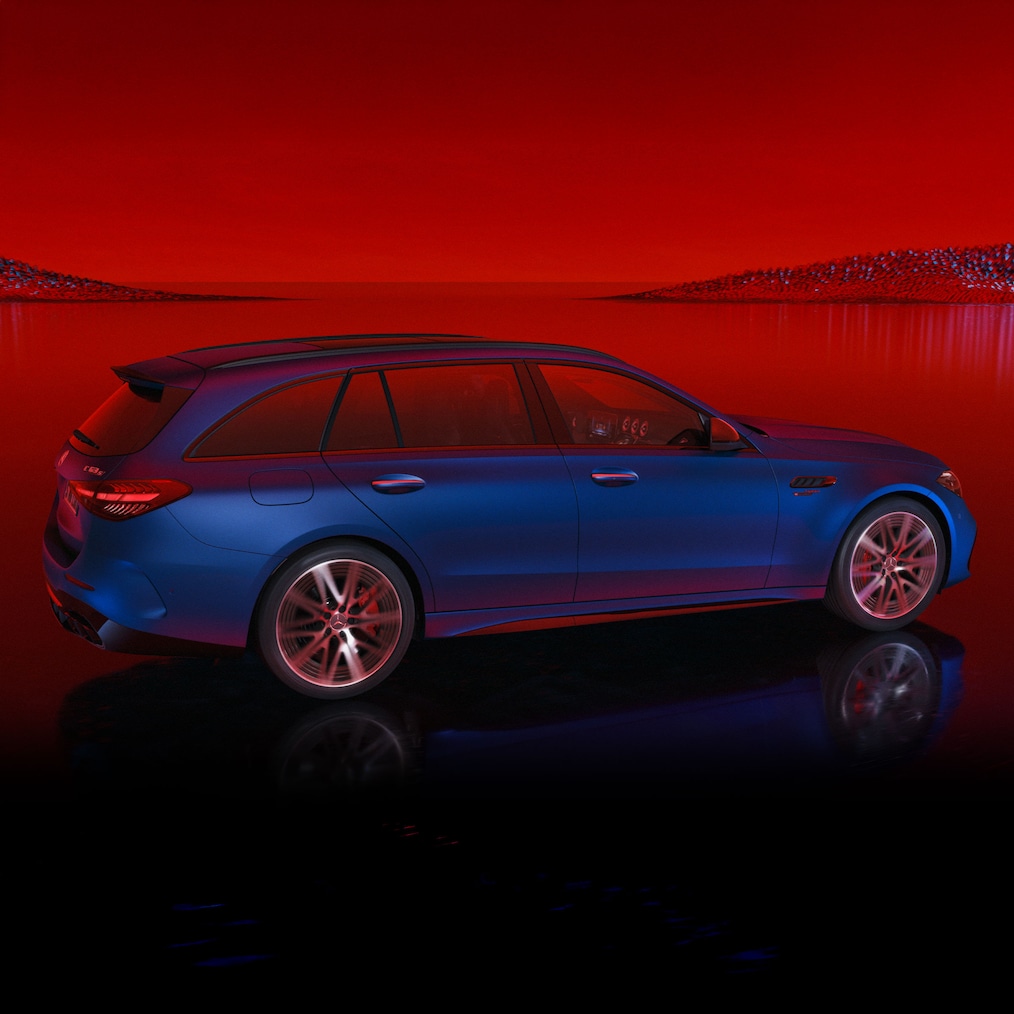 Mercedes-AMG C 63 S E PERFORMANCE Estate painted in MANUFAKTUR spectral blue magno, side view against a red background.