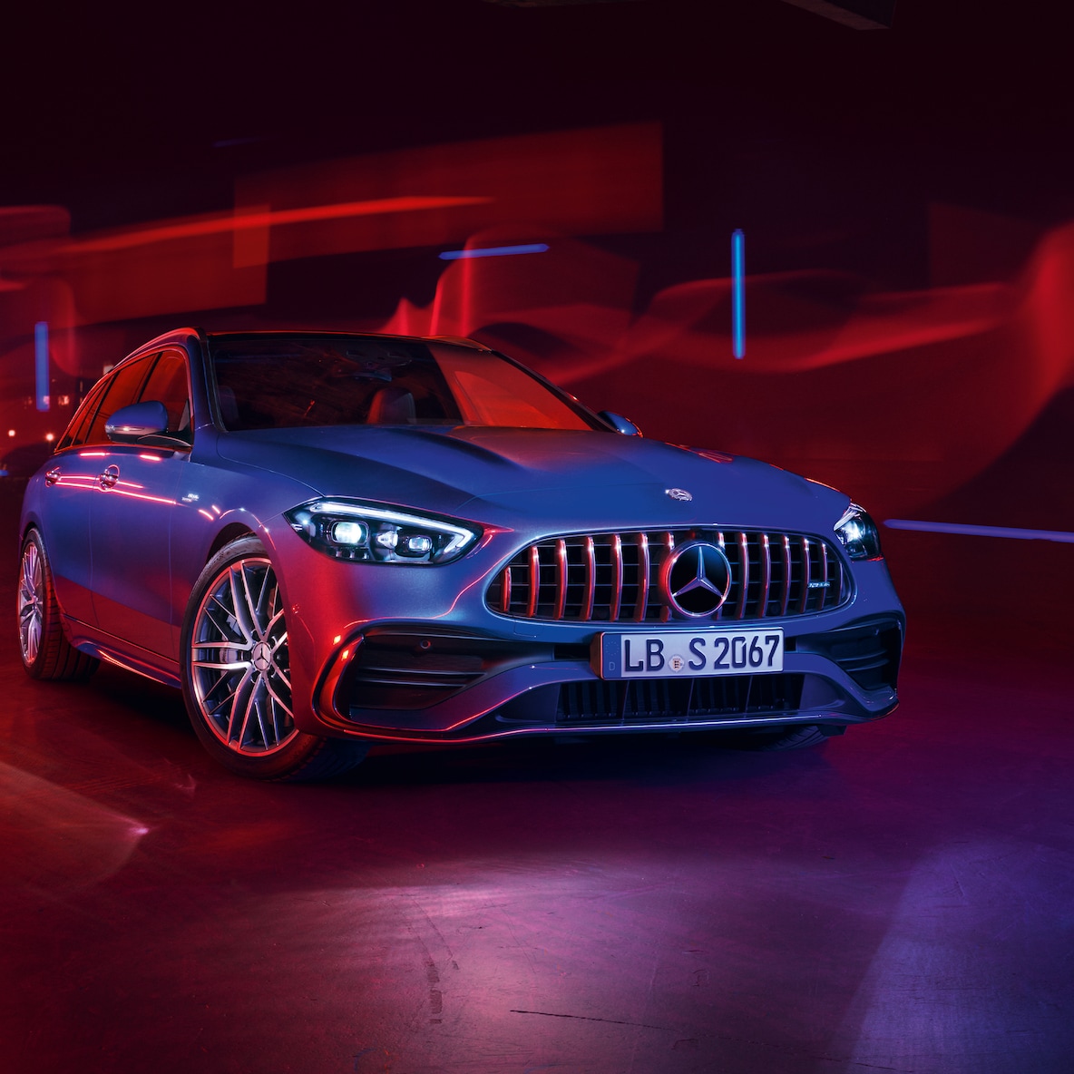 Mercedes-AMG C 43 in the front view against a red background.