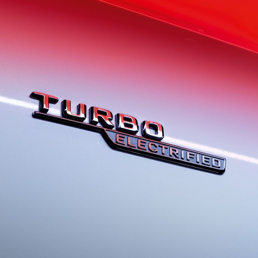 Close-up of the TURBO ELECTRIFIED badge on the front wings.