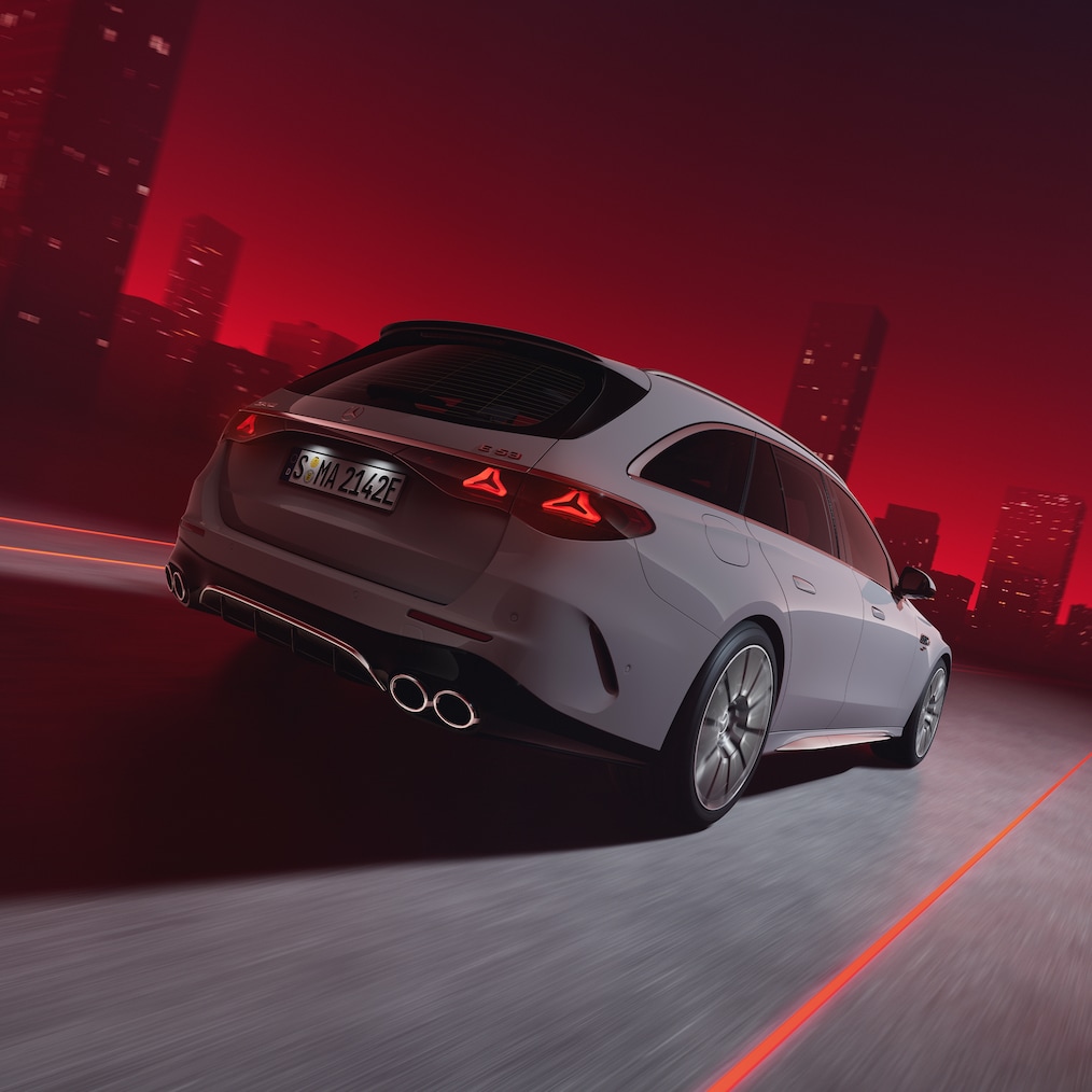 Close-up of AMG rear apron in black with 2 round twin tailpipe trim elements in high-gloss chrome.