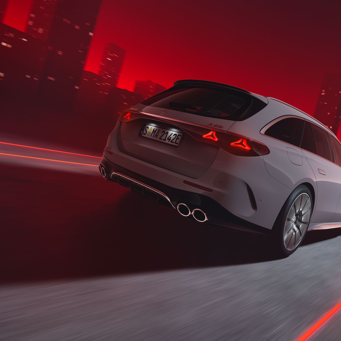 Rear view of a driving Mercedes-AMG E 53 HYBRID 4MATIC+ Estate against a red background.