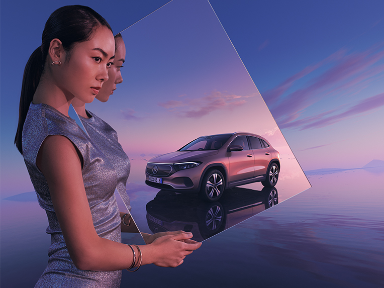 Mercedes-Benz public charging Woman holding rectangular mirror with Mercedes car in reflection