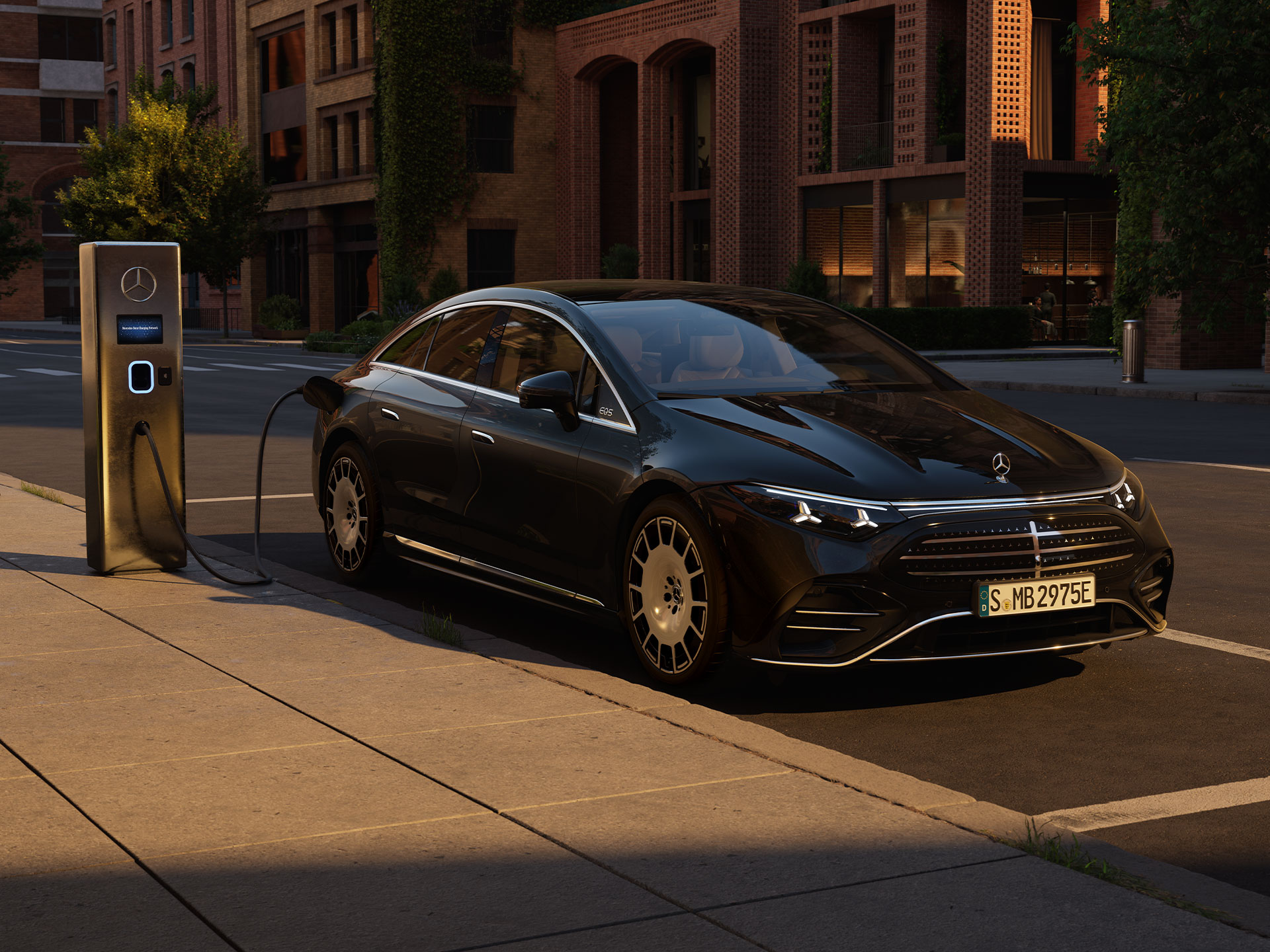 Range & Charging | EQS | Mercedes-Benz The new all-electric EQS from Mercedes-Benz charging in front of a public charging station.