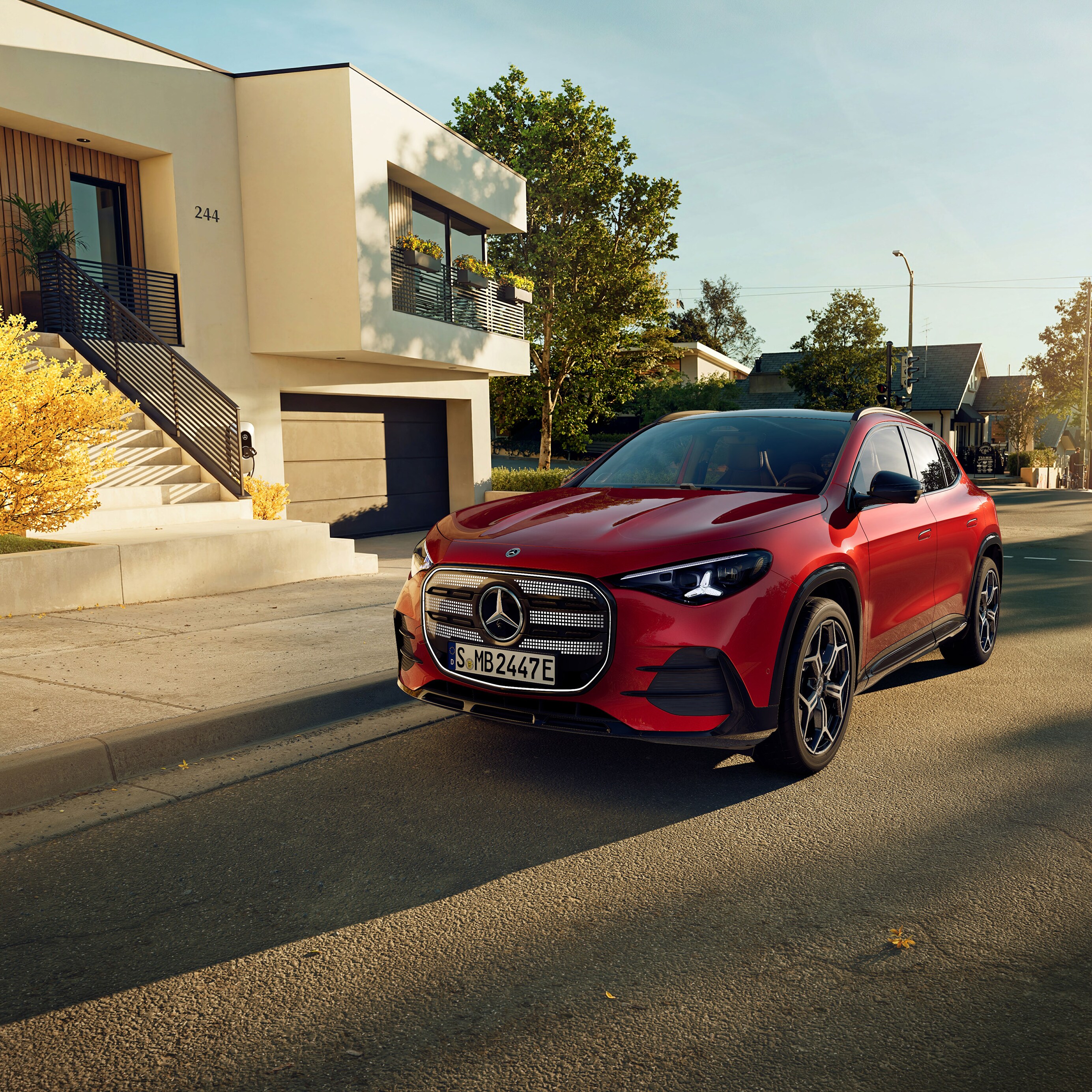 The all-new electric GLA from Mercedes-Benz parking in a parking space next to a coffee shop.