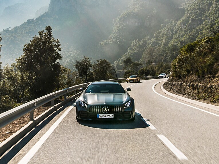 Frontal view of a Mercedes-AMG GT R out driving on the road.