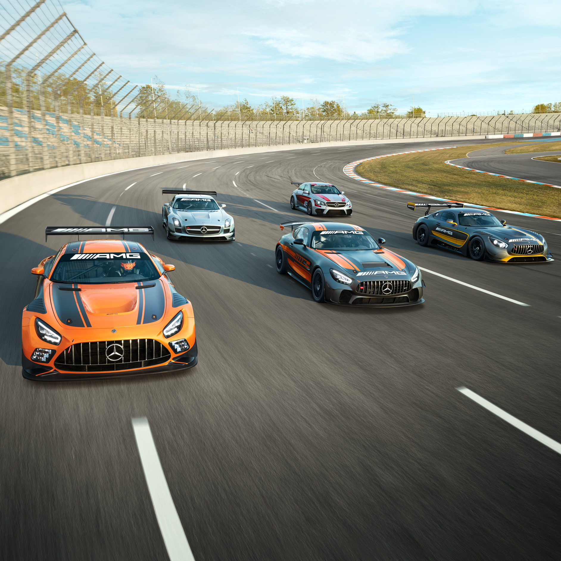 AMG Experience | Mercedes-AMG Several Mercedes-AMG vehicles on a race track.