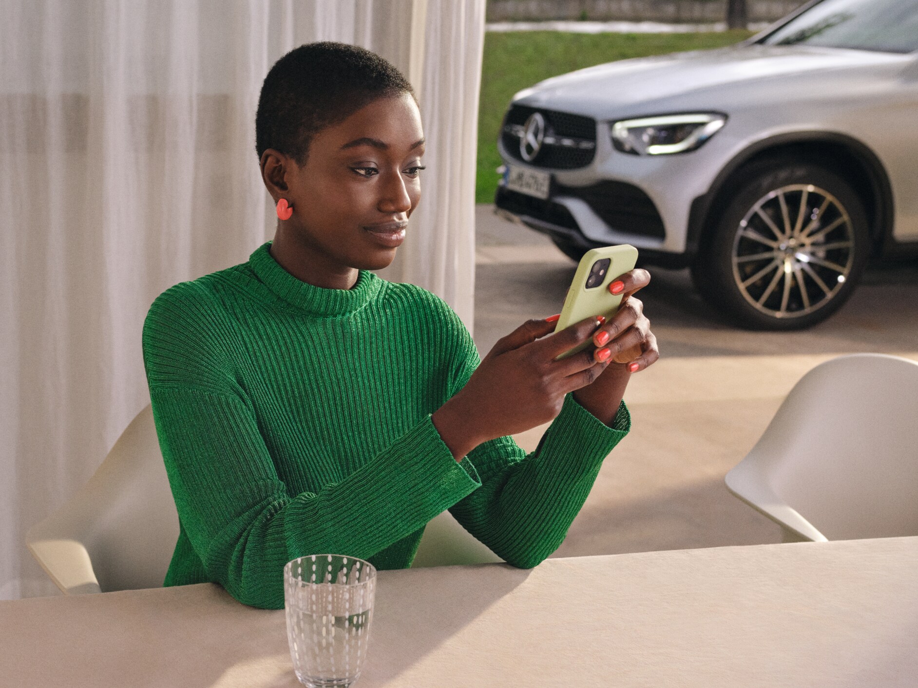 A woman checks the status of her vehicle on her smartphone.