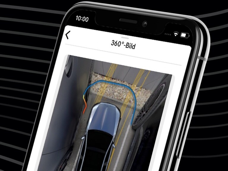 A Mercedes-Benz conveniently steered into a tight parking space using the Mercedes me Remote Parking Assist App and the 360° view on a smartphone.
