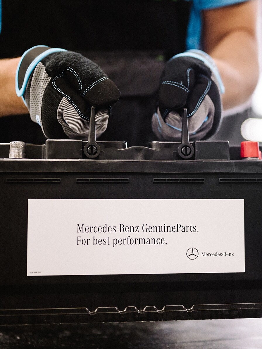 A Mercedes-Benz technician checks the vehicle's electrical system battery.
