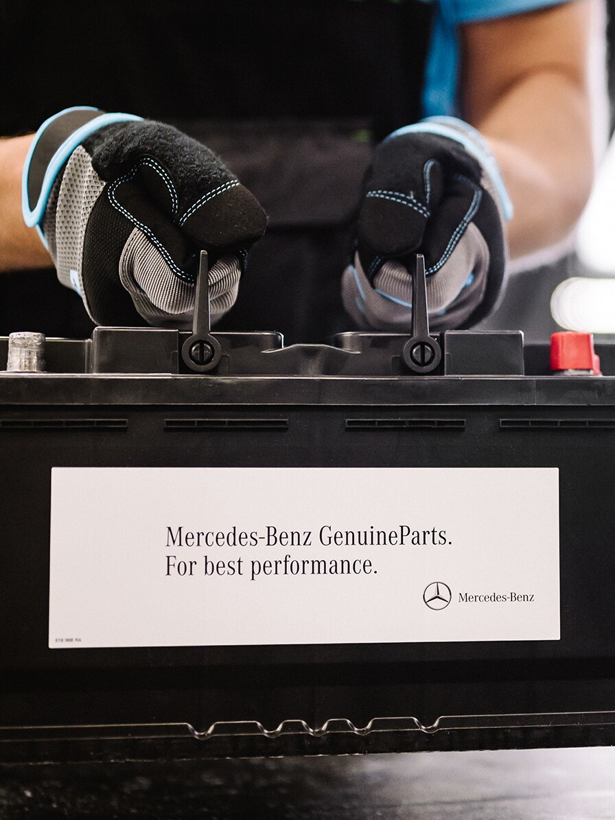 A Mercedes-Benz technician checks the vehicle's electrical system battery.