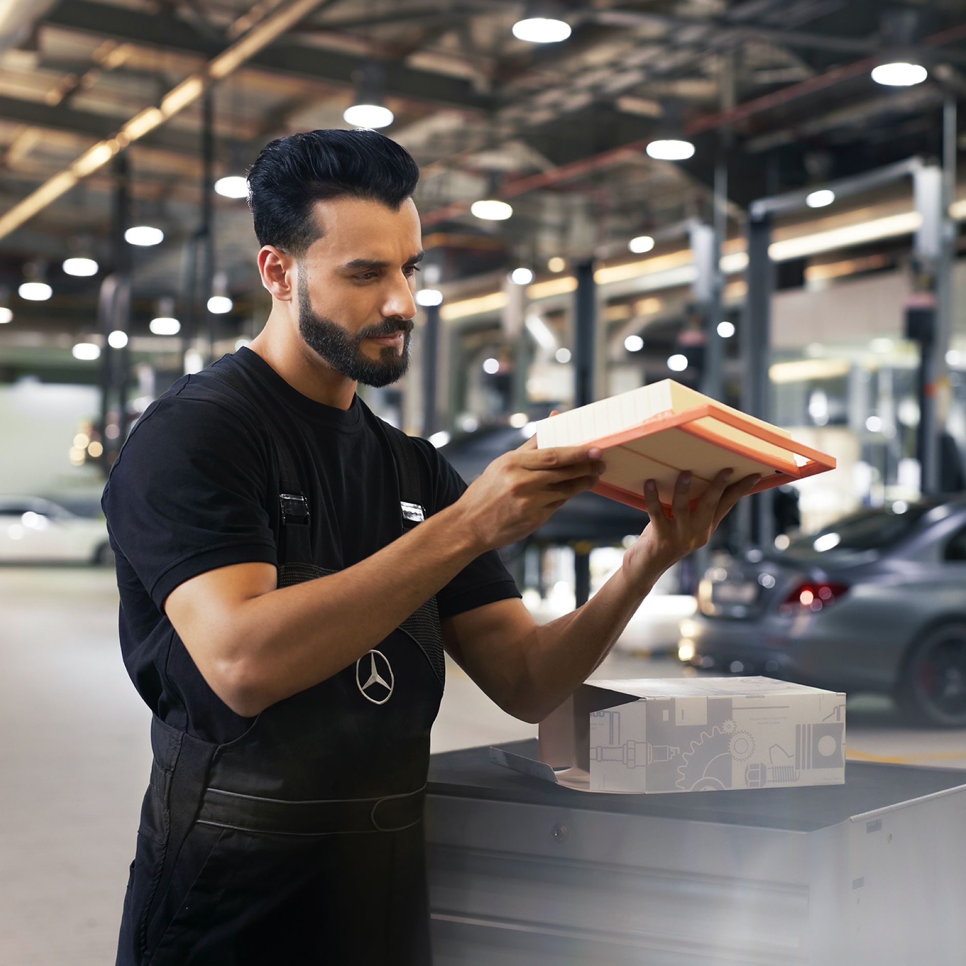 Mercedes-Benz genuine engine air filter A Mercedes-Benz technician inspects an engine air filter.