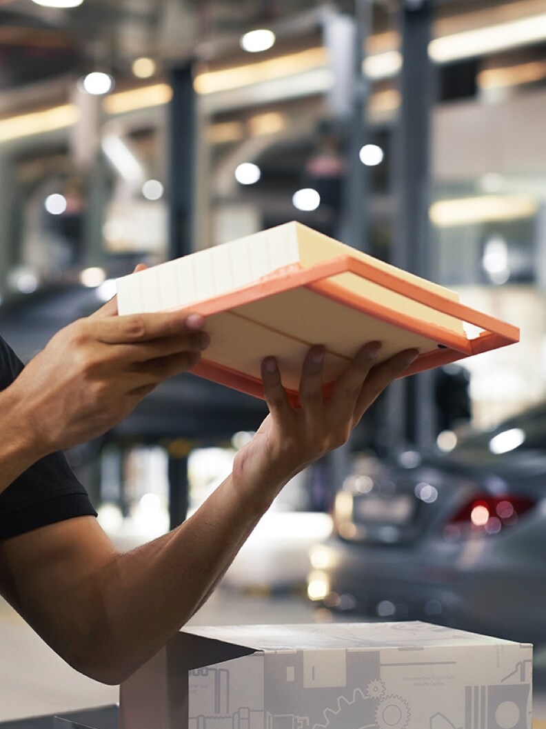 A Mercedes-Benz technician inspects an engine air filter.