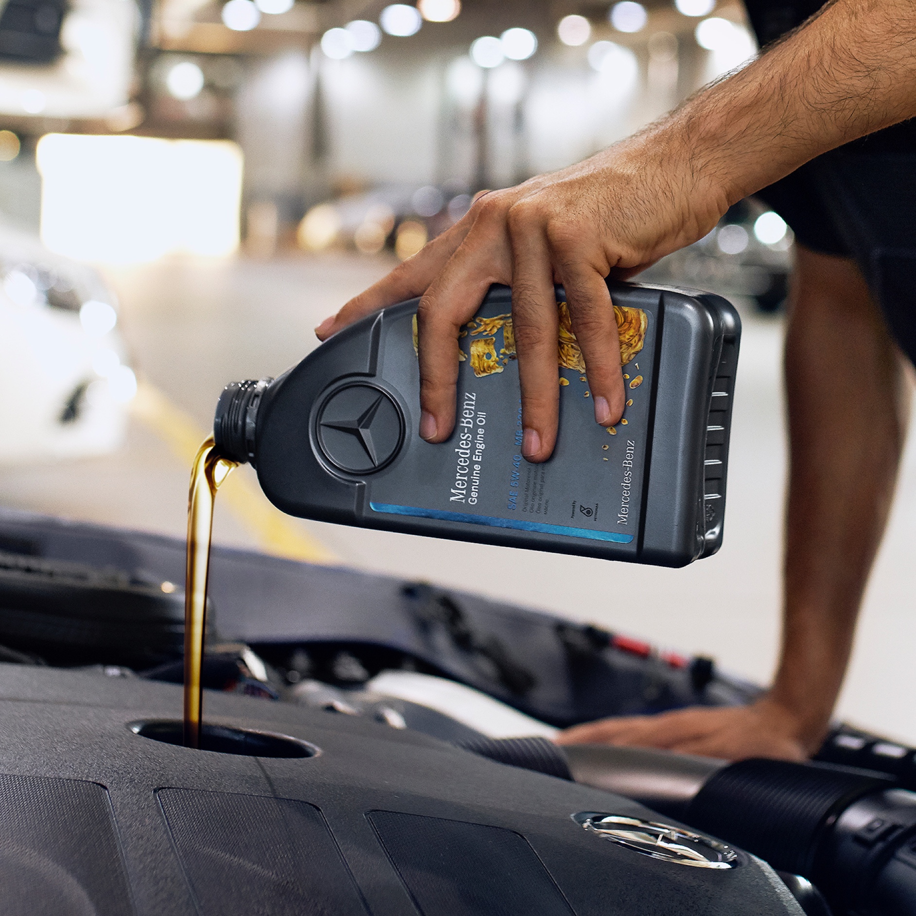 Engine oil | Mercedes-Benz A Mercedes-Benz technician refills genuine engine oil.