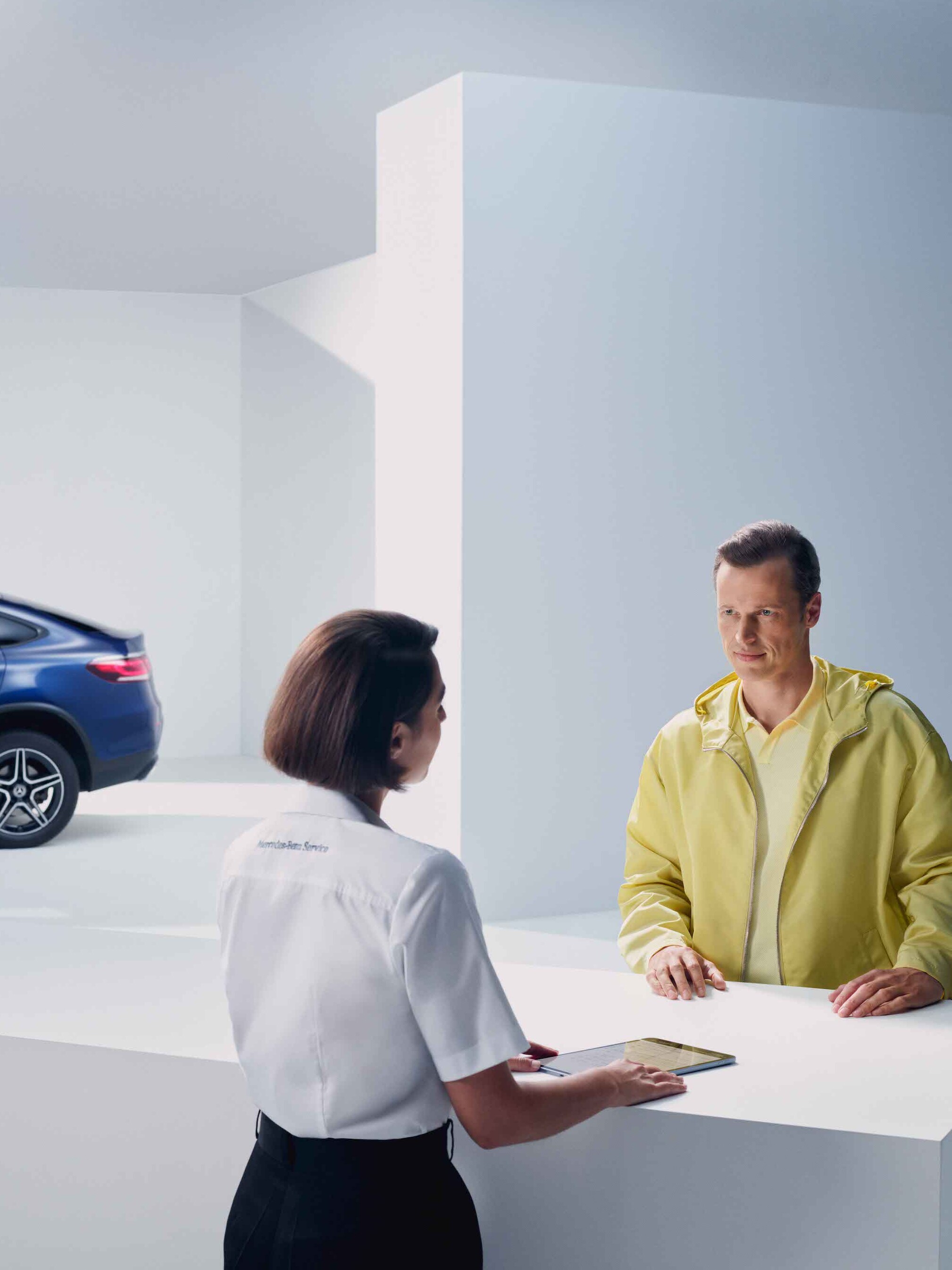 A man gets advice from a Mercedes-Benz employee.