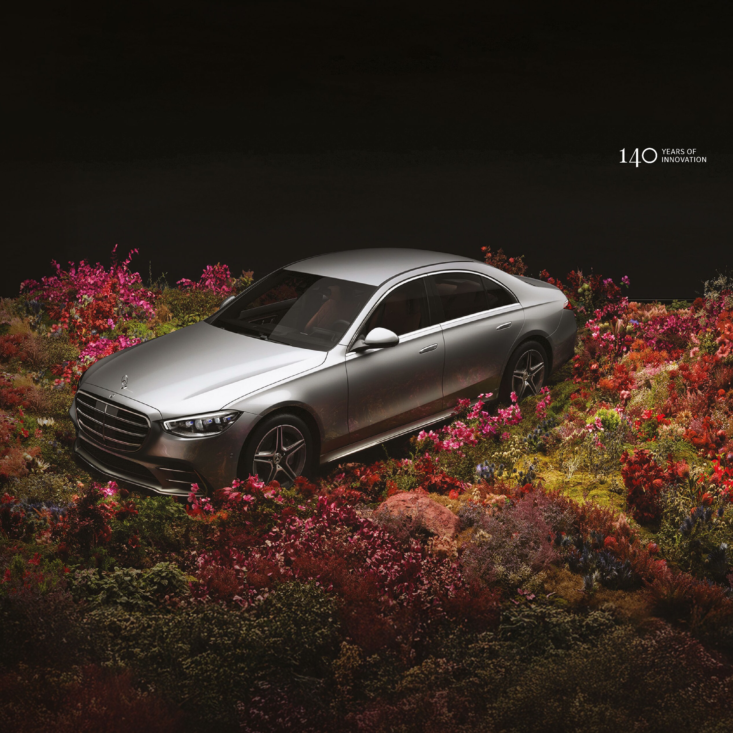 A Mercedes-Benz S-Class in a field of flowers.