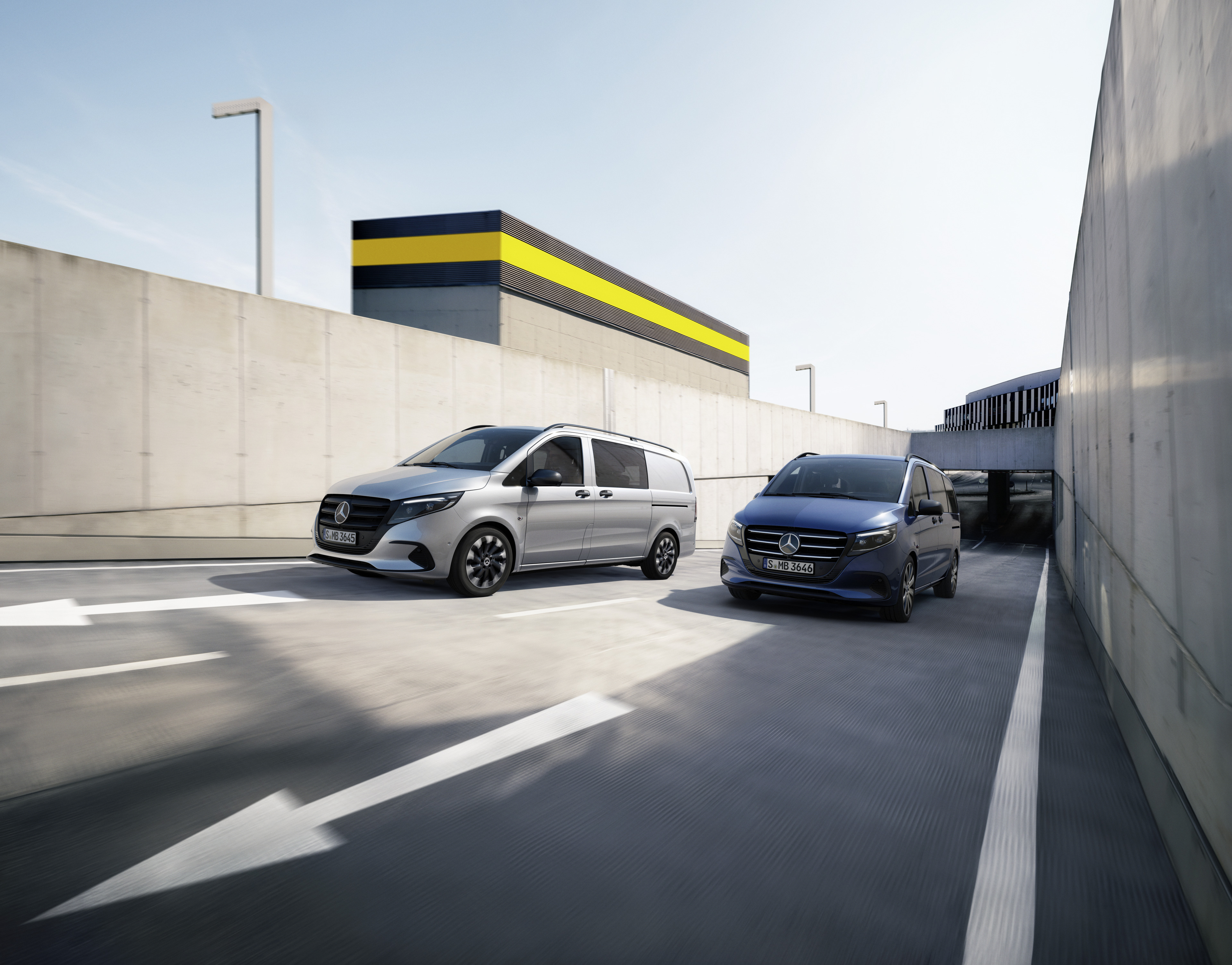 Safety and Support | Mercedes-Benz Vans Two Mercedes-Benz vans (silver and blue) in a car park with a "Platinum 2024 Commercial Van Safety" badge.