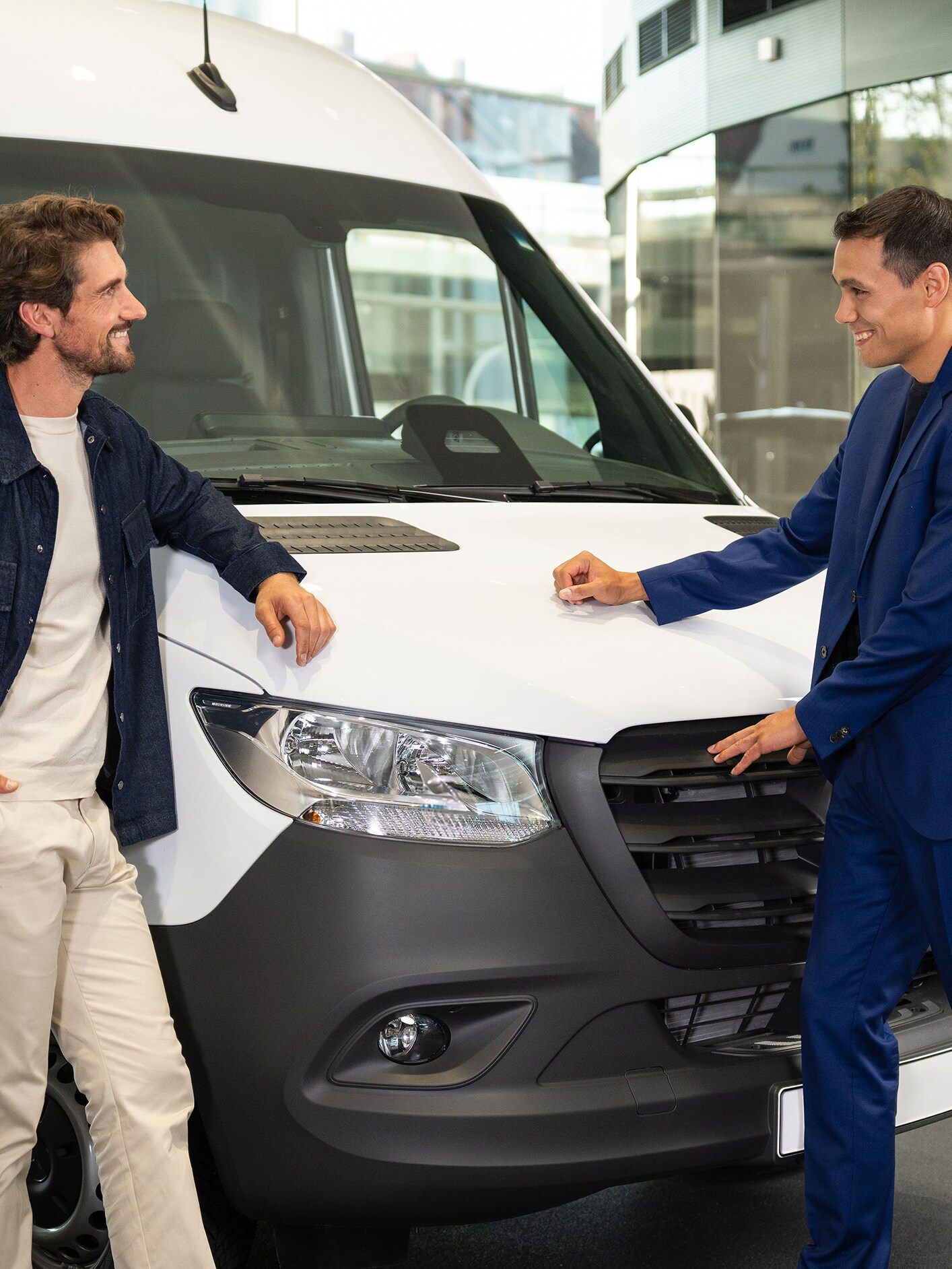 A person sat on a sofa looking at a tablet device.