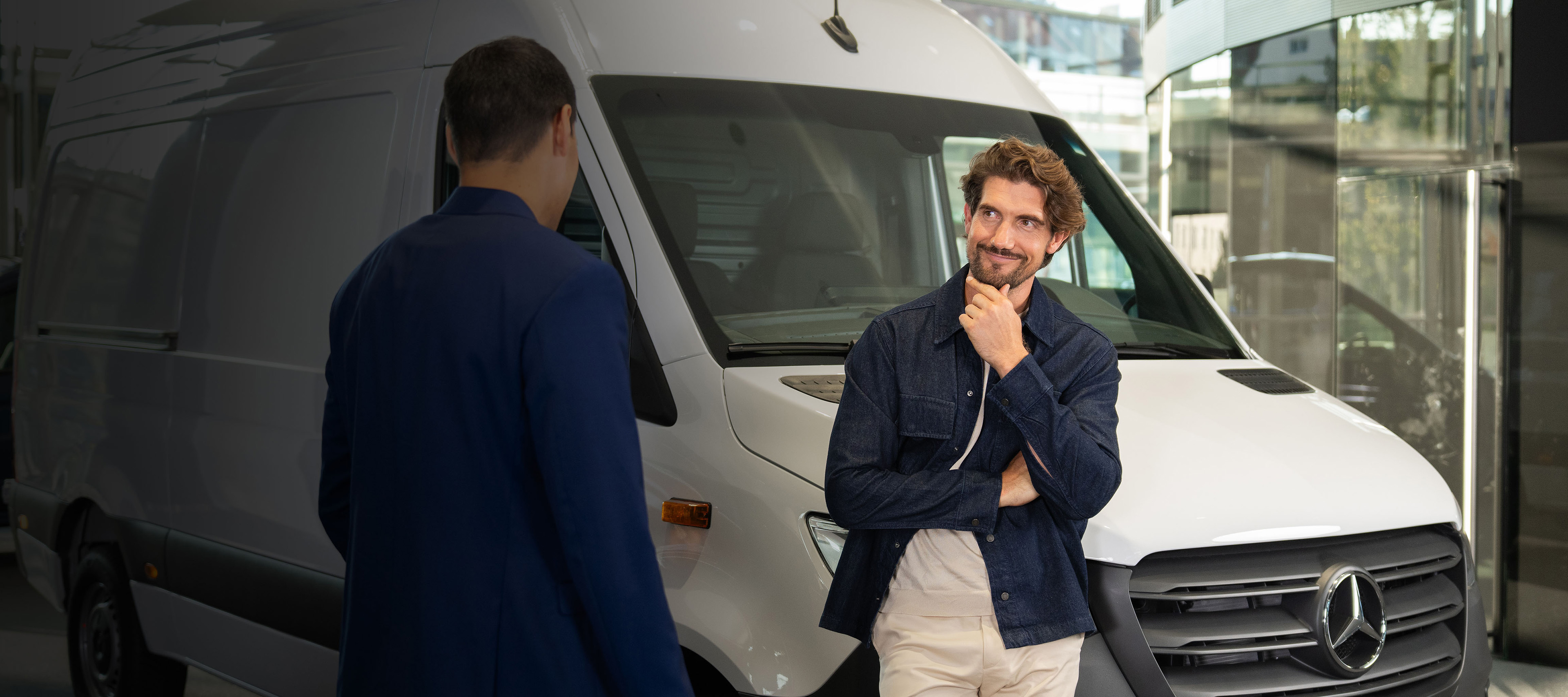 Leasing and Financing Header Two people talking in front of a Mercedes-Benz van.