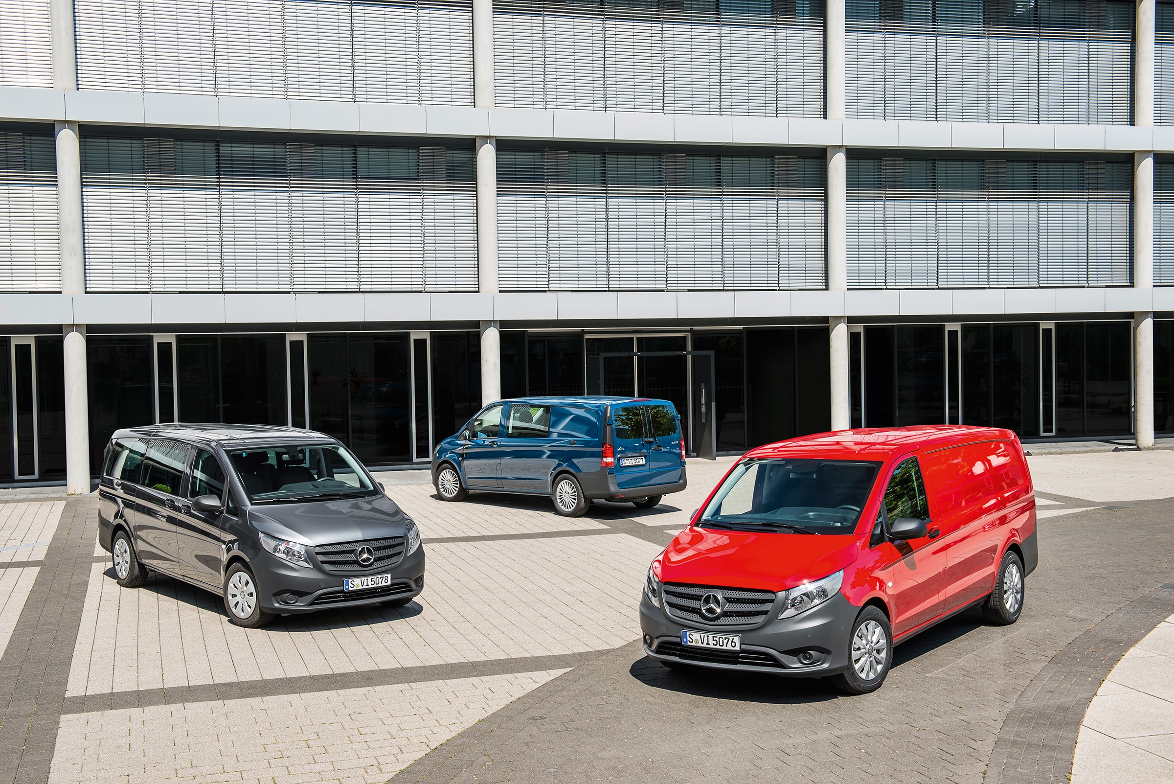 The third generation of Mercedes-Benz Vitos | Commercial Vehicles History | Mercedes-Benz Several Mercedes-Benz Vitos parked in front of modern office building