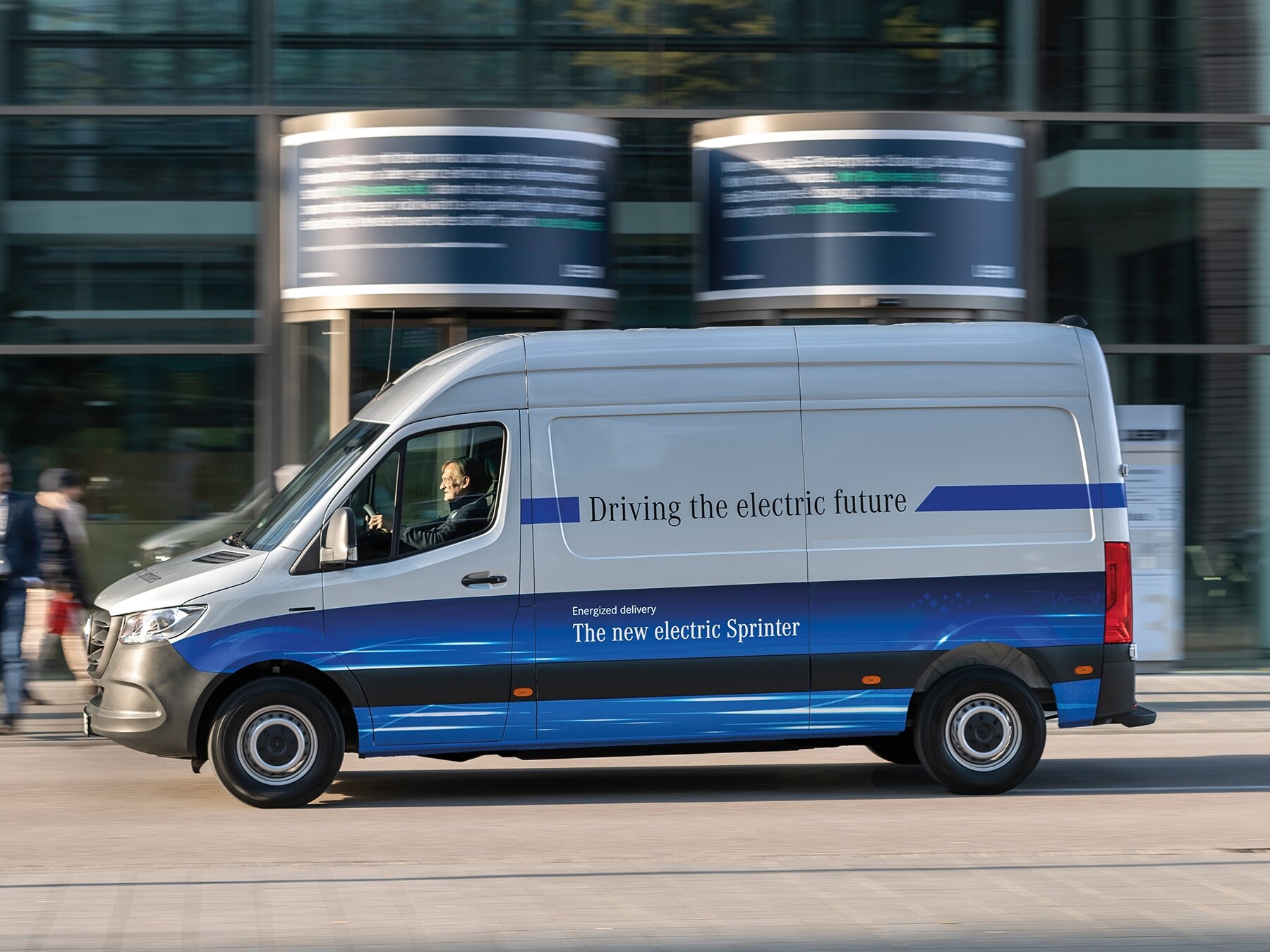 Mercedes-Benz eSprinter Panel Van delivery van driving through modern city street