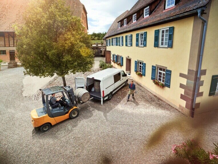 A Mercedes-Benz van with open load compartment.