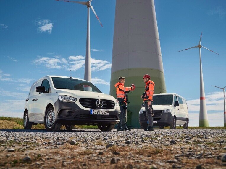 Two Mercedes-Benz vans on a construction site.