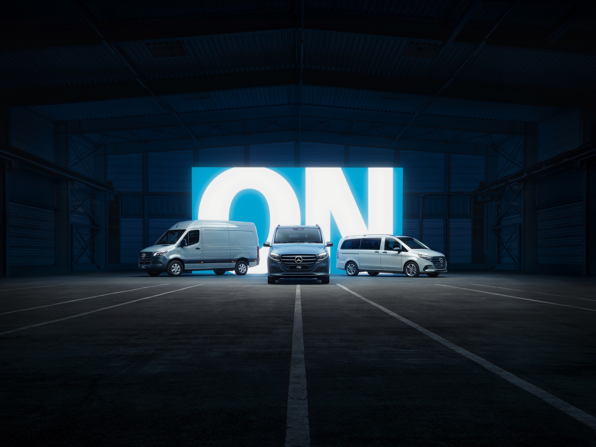 Mercedes‑Benz electric van lineup with eSprinter and eVito in illuminated showroom.