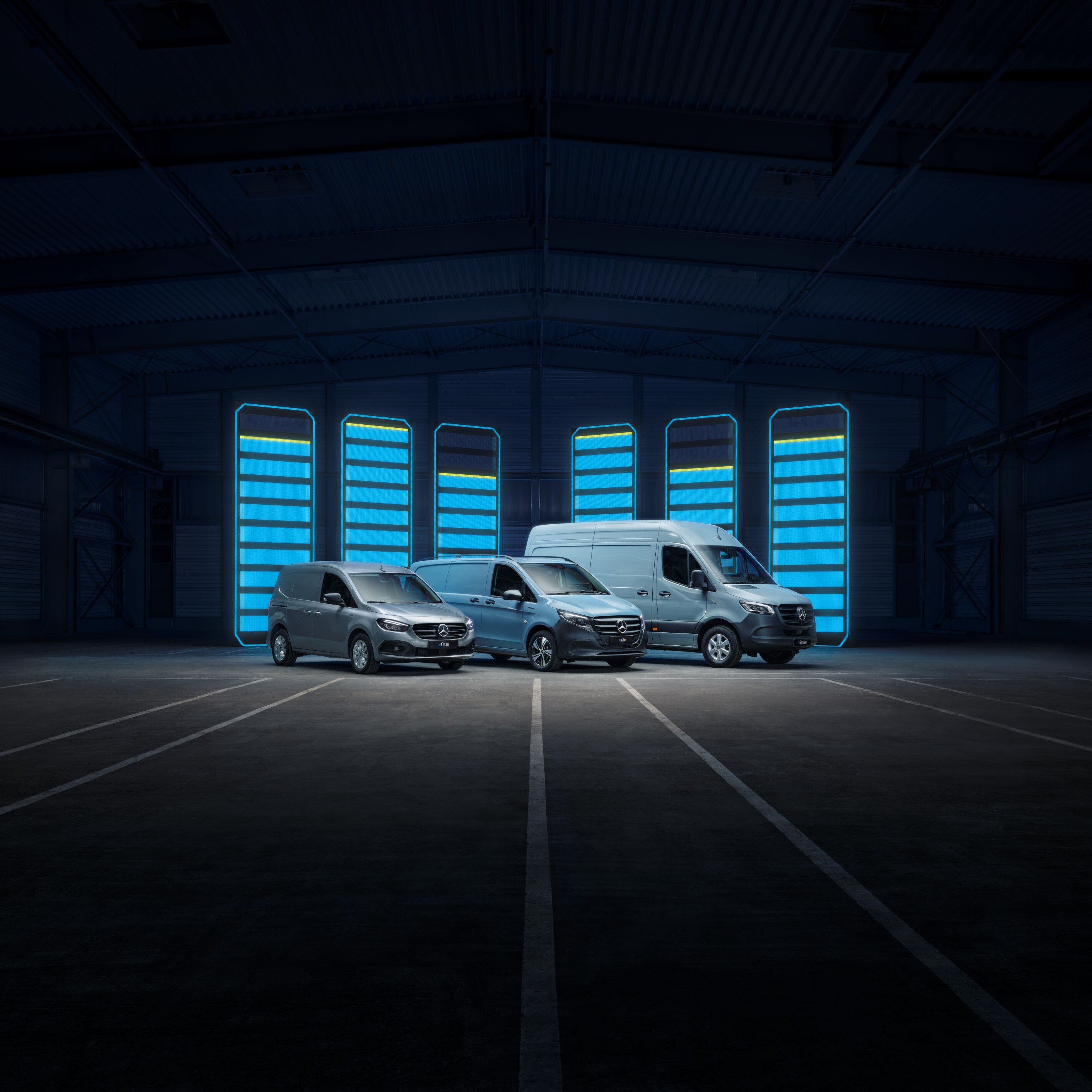 Mercedes-Benz eSprinter, eVito and eCitan electric vans parked in an indoor parking lot.