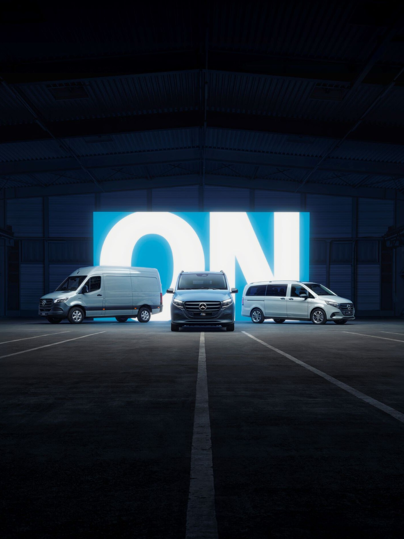 Mercedes-Benz electric vans in a dark setting with "ON" illuminated in the background.