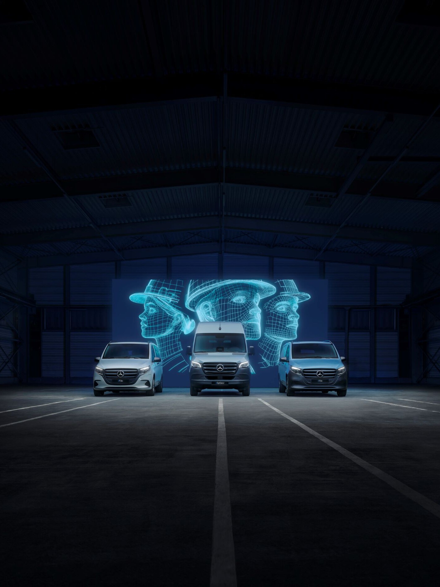 Mercedes-Benz electric vans (eCitan, eVito, eSprinter) in a dark warehouse with digital worker holograms.
