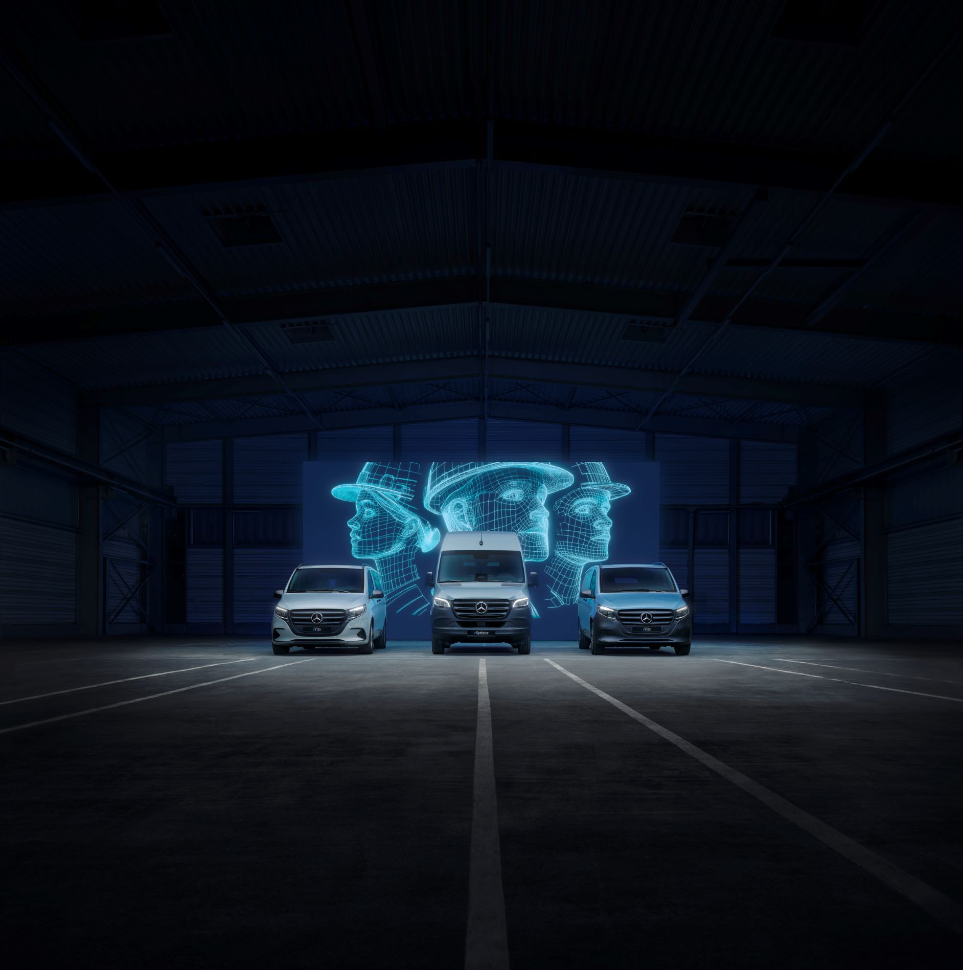 Sustainability | eVito Panel Van | Mercedes-Benz Mercedes-Benz electric vans (eCitan, eVito, eSprinter) in a dark warehouse with digital worker holograms.