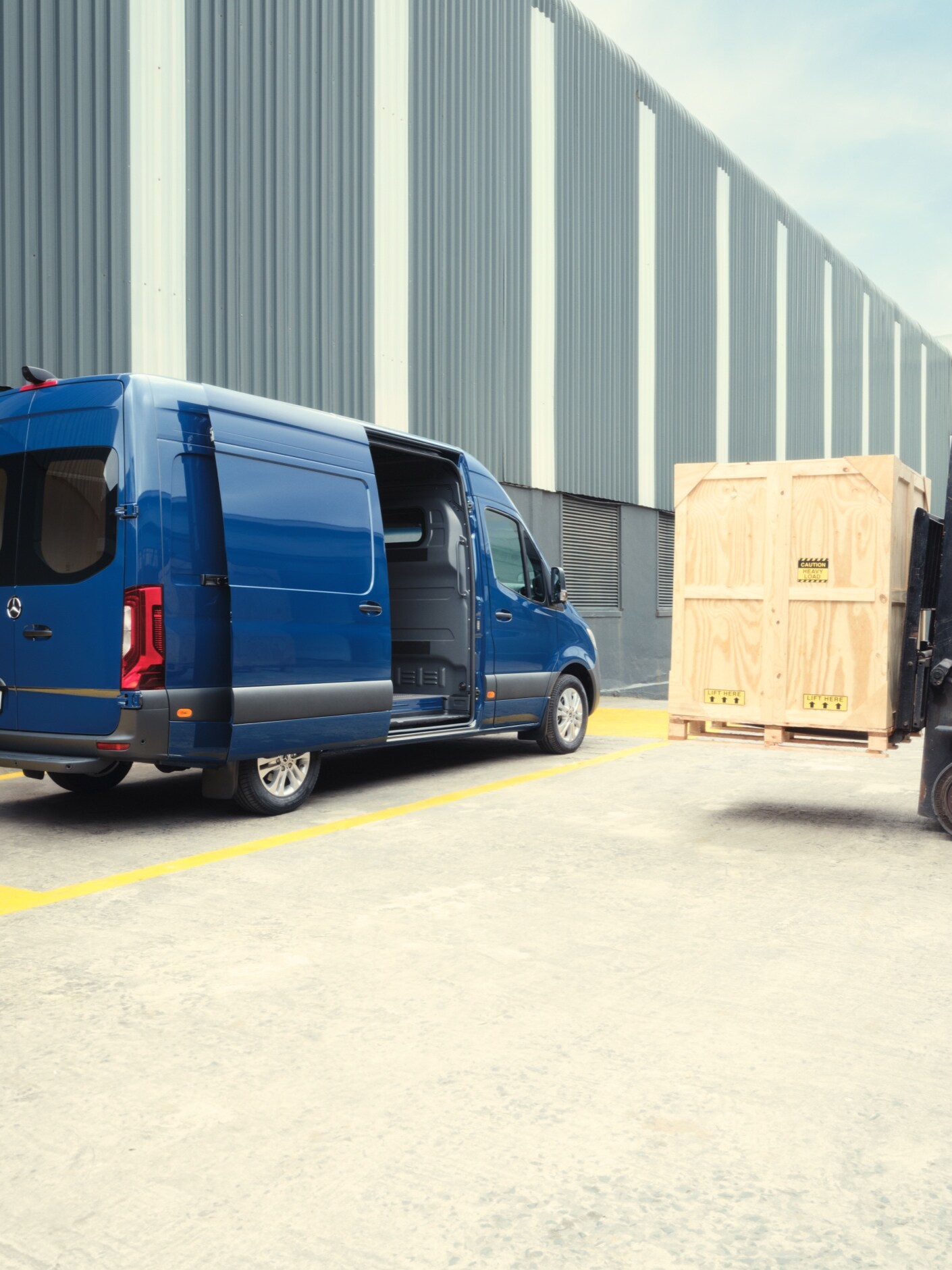 The Mercedes-Benz Sprinter Panel Van is being loaded by a fork-lift truck.