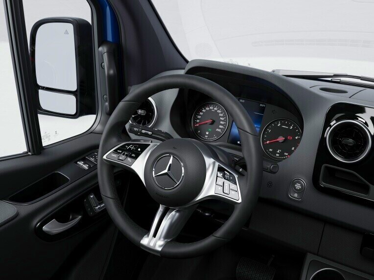 The multifunction steering wheel with touch controls for cruise control in the Mercedes-Benz Sprinter Panel Van.