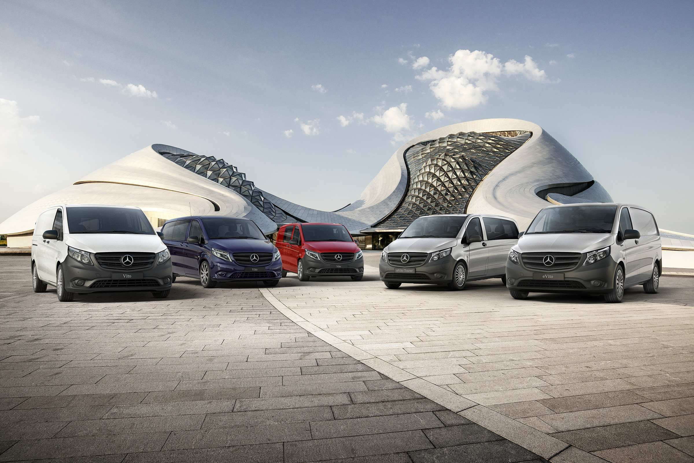 Vito Range | All Vito | Mercedes-Benz vans The Mercedes-Benz eVito panel van, Vito panel van, Vito Crew, eVito Tourer and Vito Tourer stand side by side in front of a futuristic building