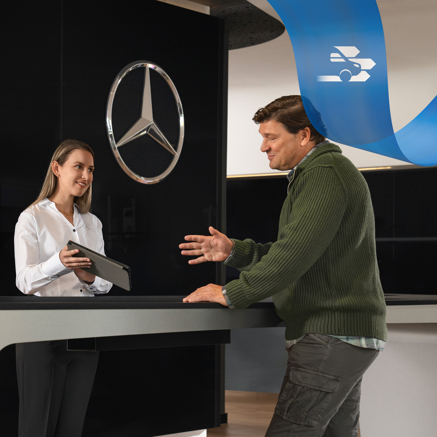 Mercedes-Benz | Van Care | Individual Support Mercedes-Benz employee provides support to a customer while standing at a reception desk.