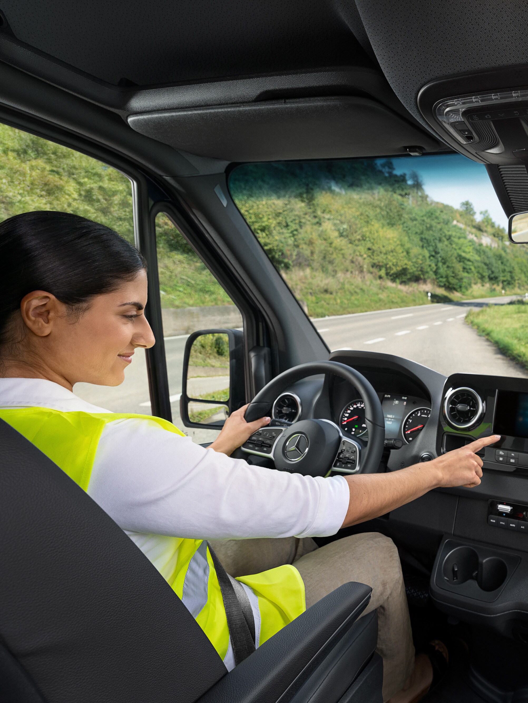 Driver checks the on-board display in her Mercedes-Benz van.
