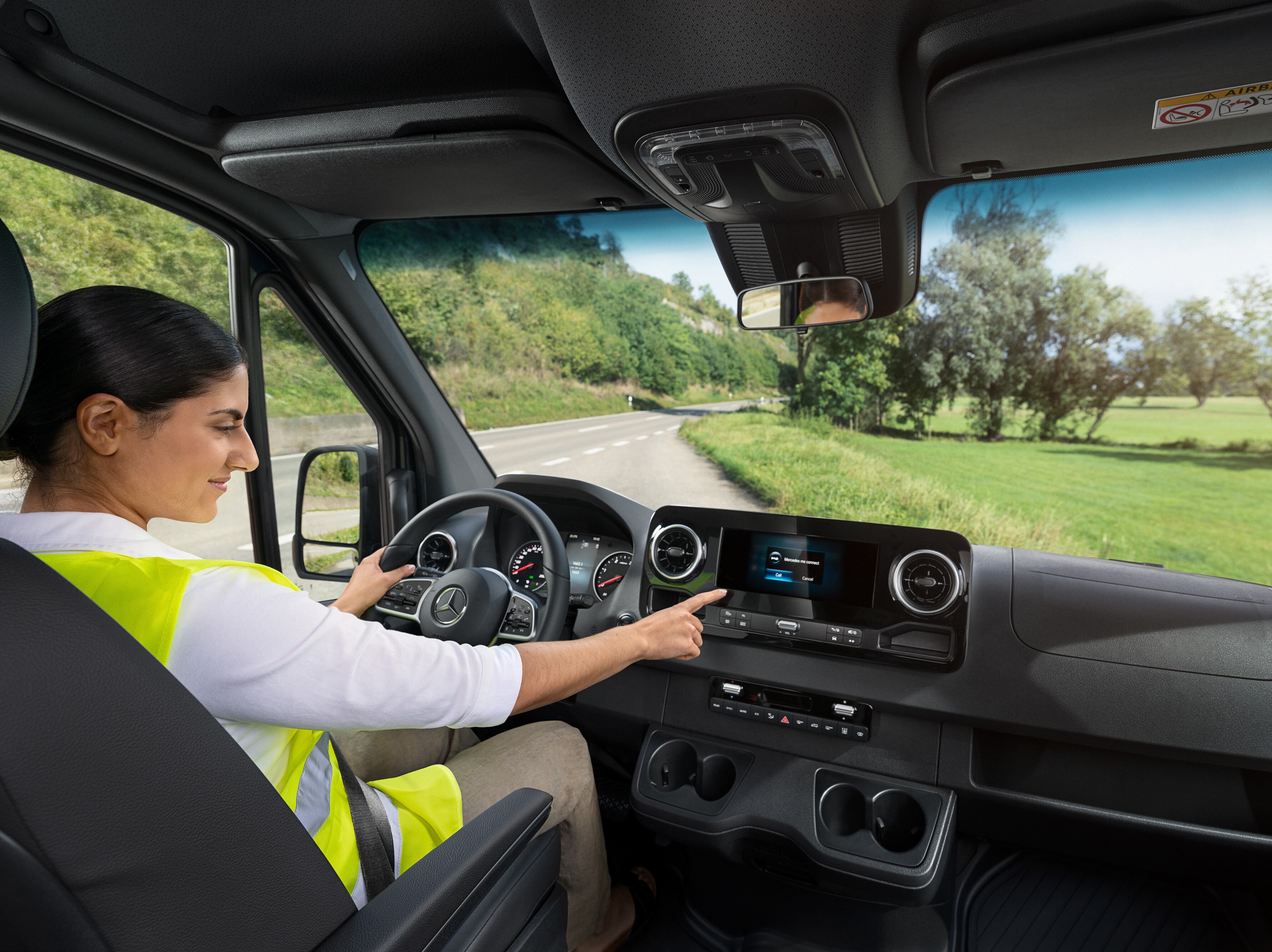 Driver checks the on-board display in her Mercedes-Benz van.