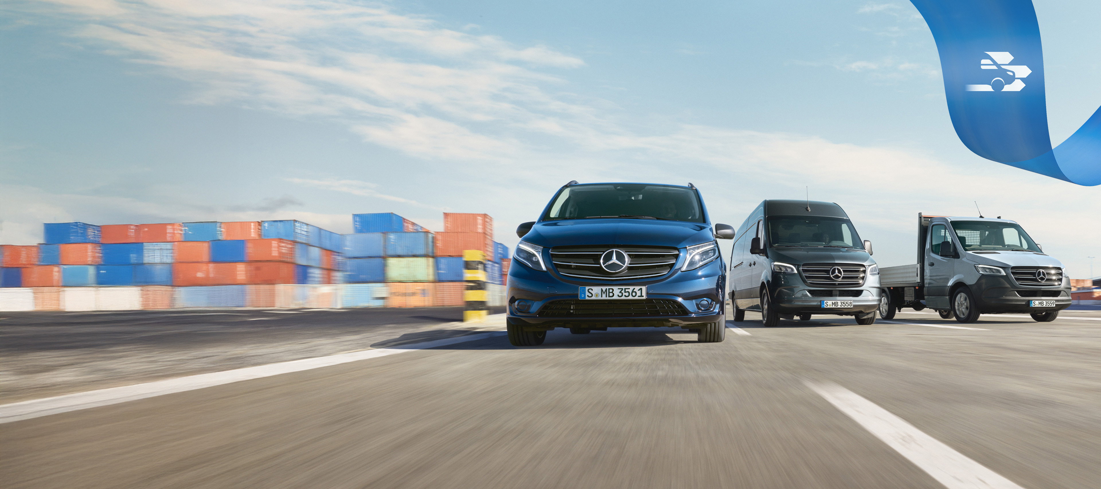 Mercedes Benz | Convenience Mobilovan A range of Mercedes-Benz vans on the road with shipping containers in the background.