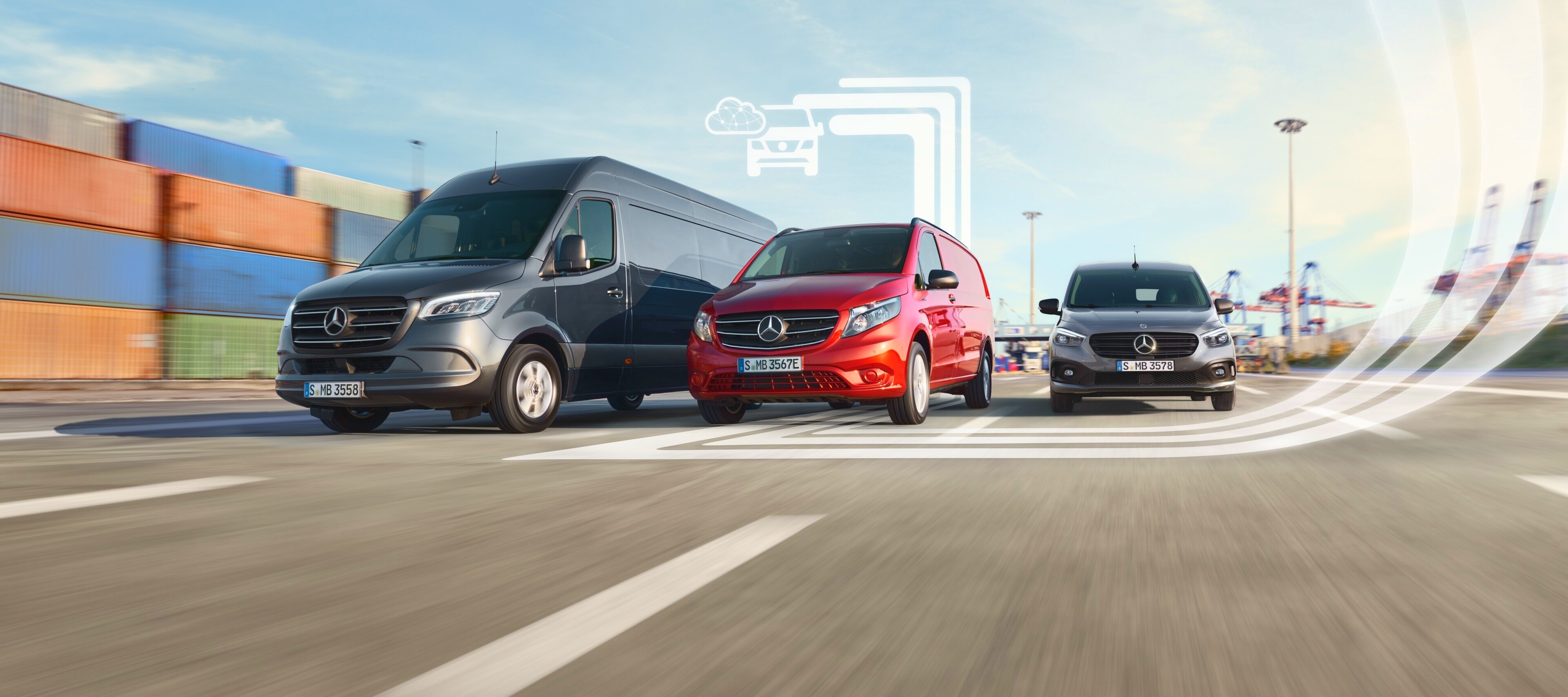 Mercedes-Benz | Services Overview | Electric Van Services Three employees standing in front of a silver Mercedes-Benz eSprinter with charging cable attached.