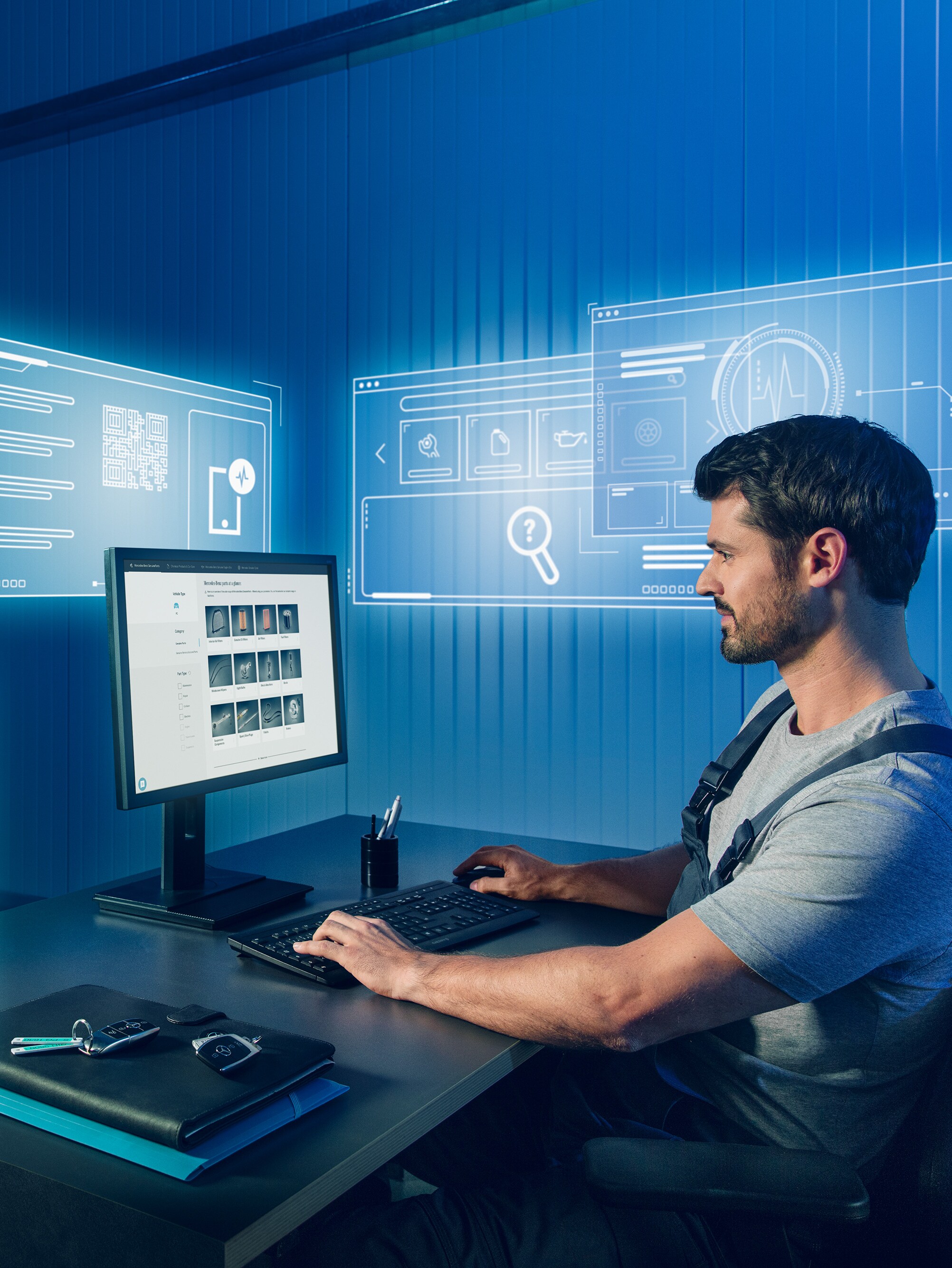 Mechanic searching for suitable Mercedes-Benz Genuine Parts in the Mercedes spare parts catalogue on the computer.