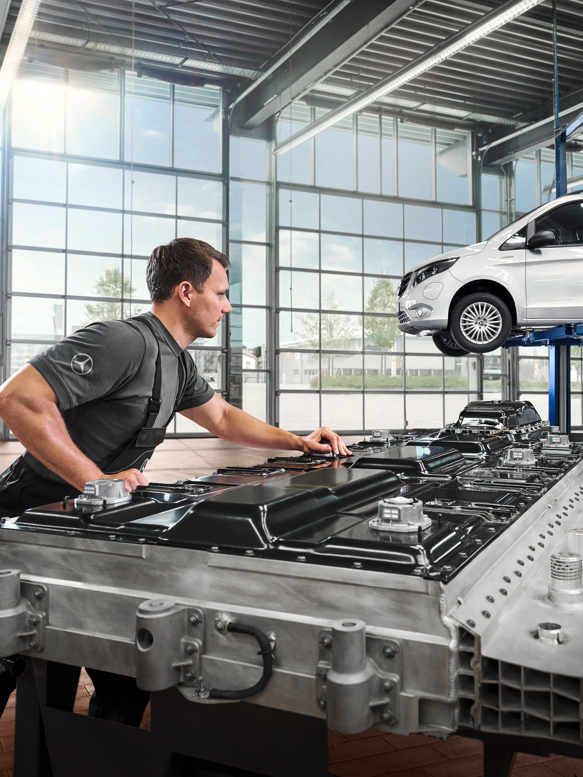 A technician checks battery modules in the workshop.