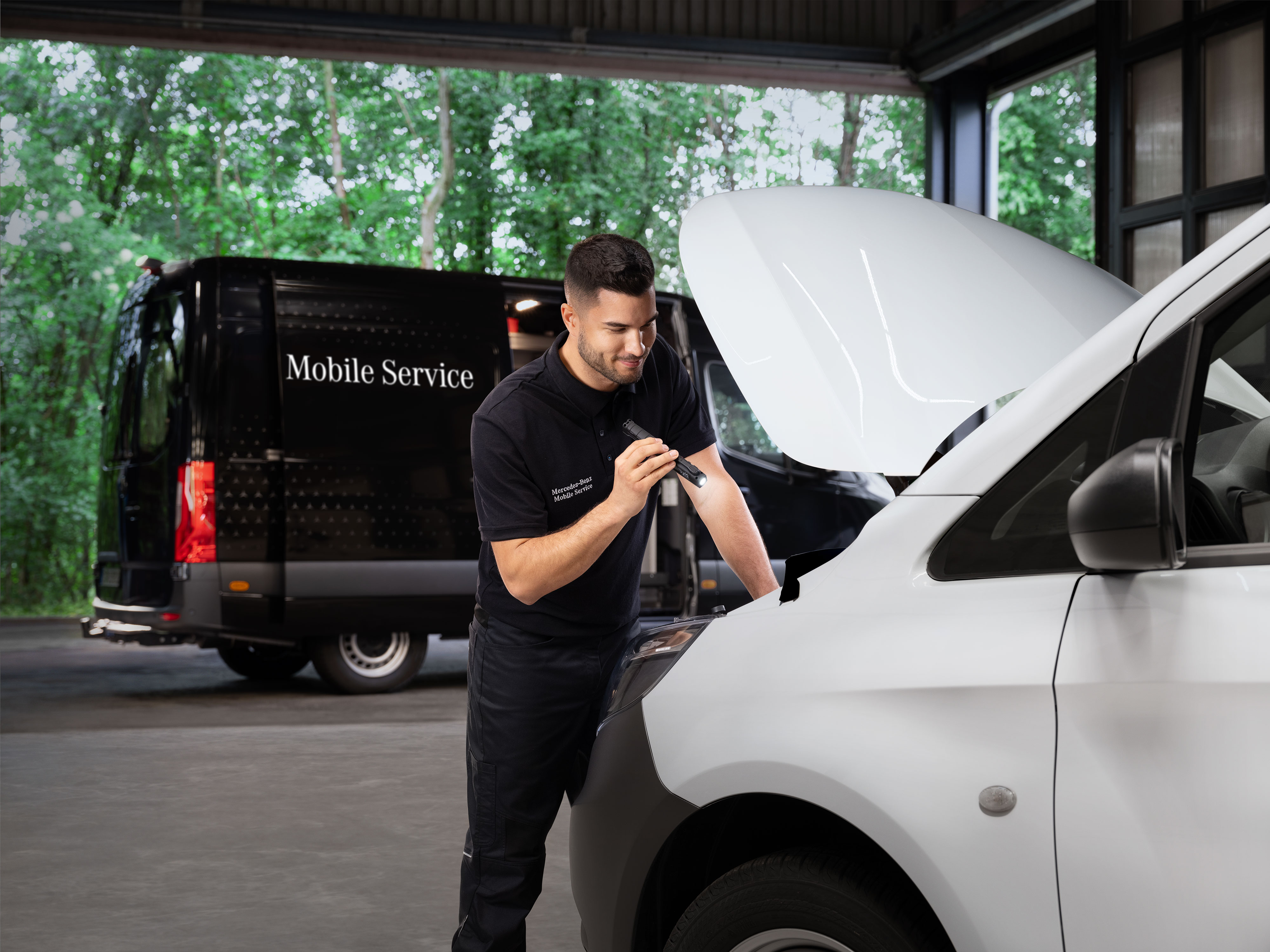 Mercedes-Benz | Maintenance | Mobile Service Mechanic inspecting the engine of a white Mercedes-Benz van.