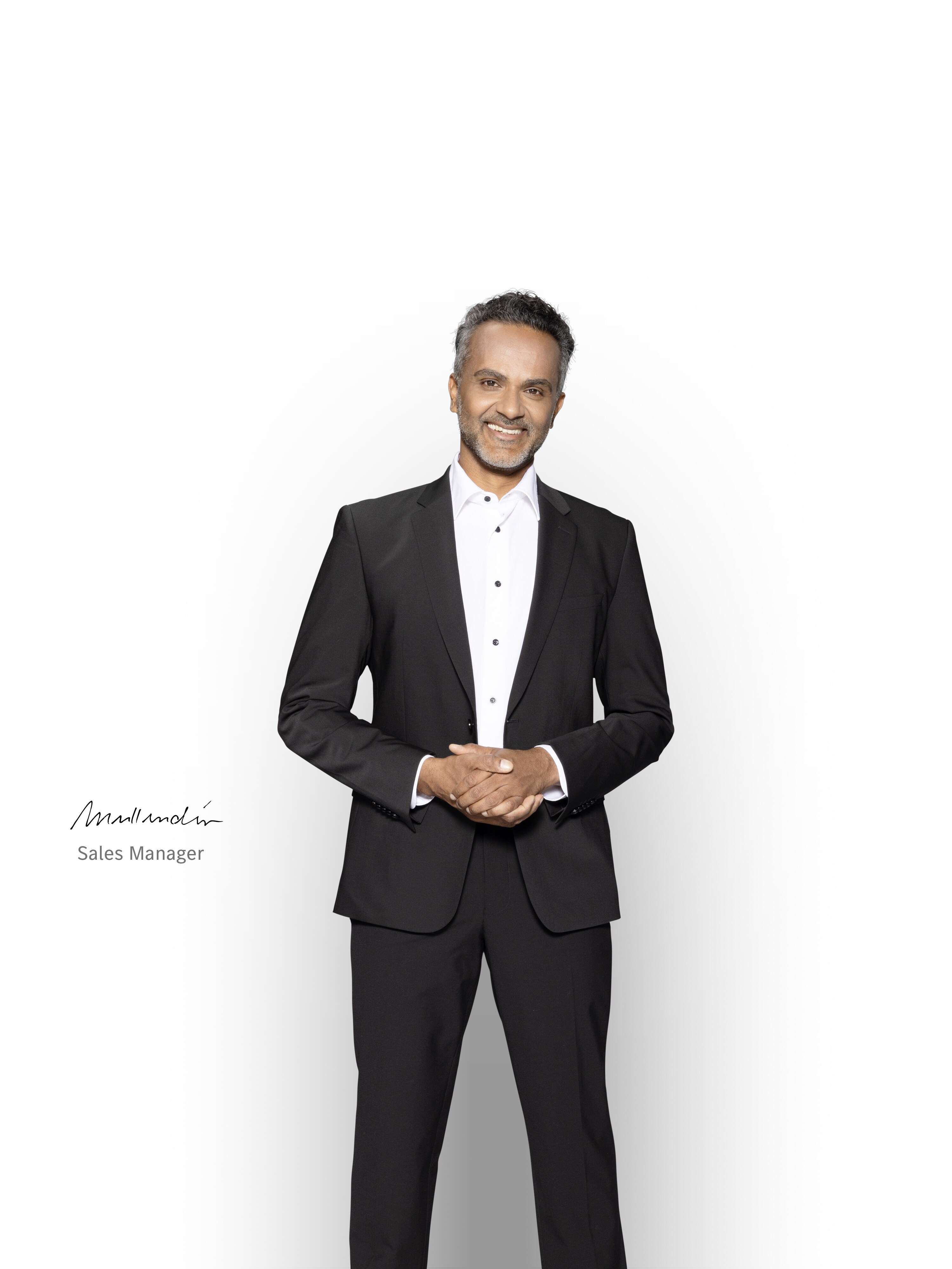 Competent Sales Manager standing and smiling to ensure support with your Mercedes-Bent electric van.