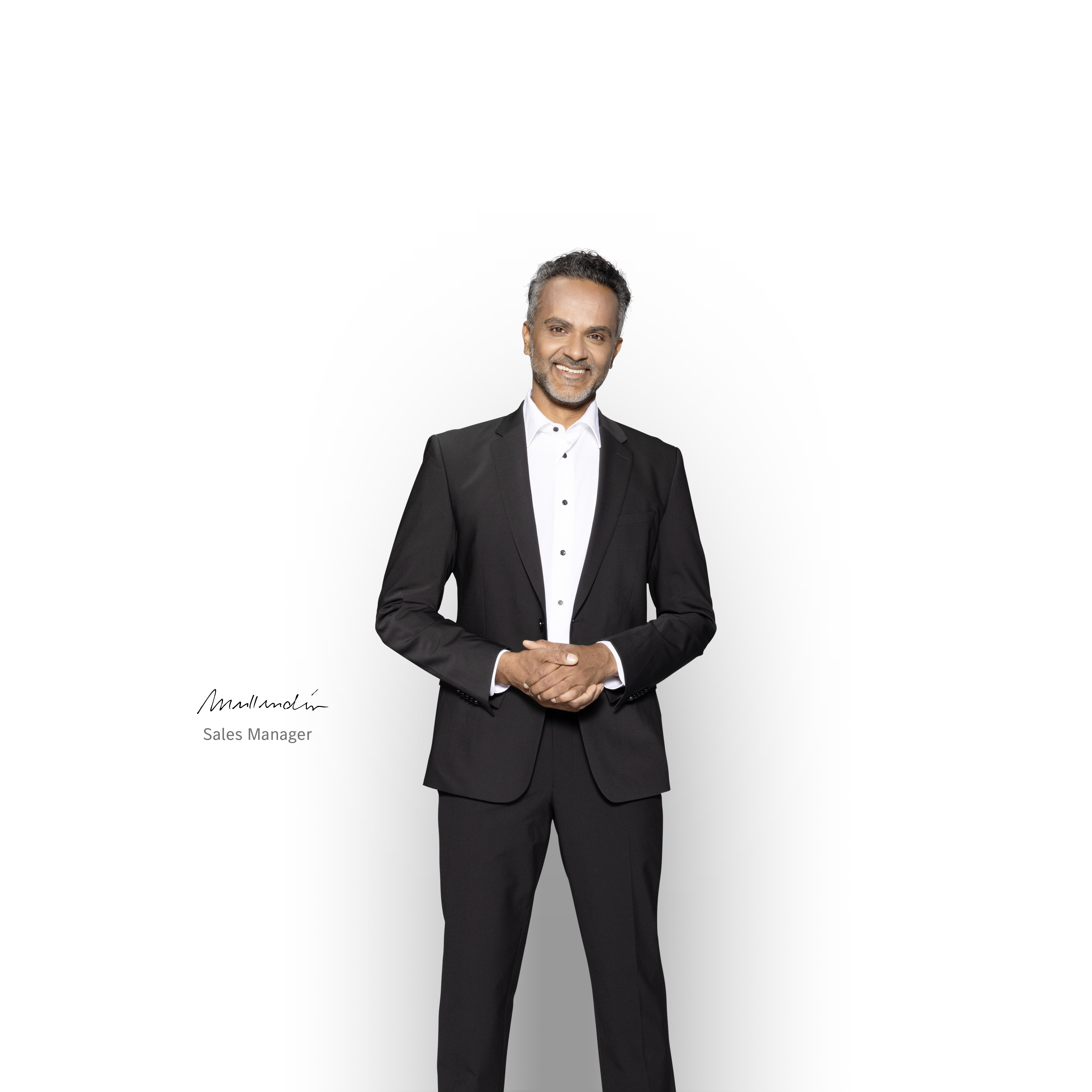 Mercedes-Benz | Electric Vehicle Service Competent Sales Manager standing and smiling to ensure support with your Mercedes-Bent electric van.