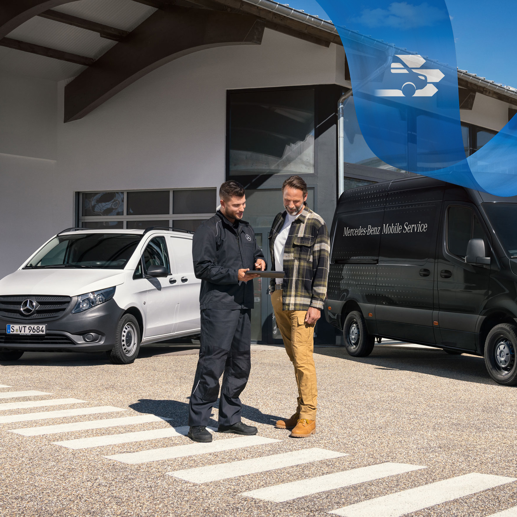 Mercedes-Benz | Vans Mobile Service Two men talking in front of a white Mercedes-Benz Vito van and black Mercedes-Benz Sprinter van.