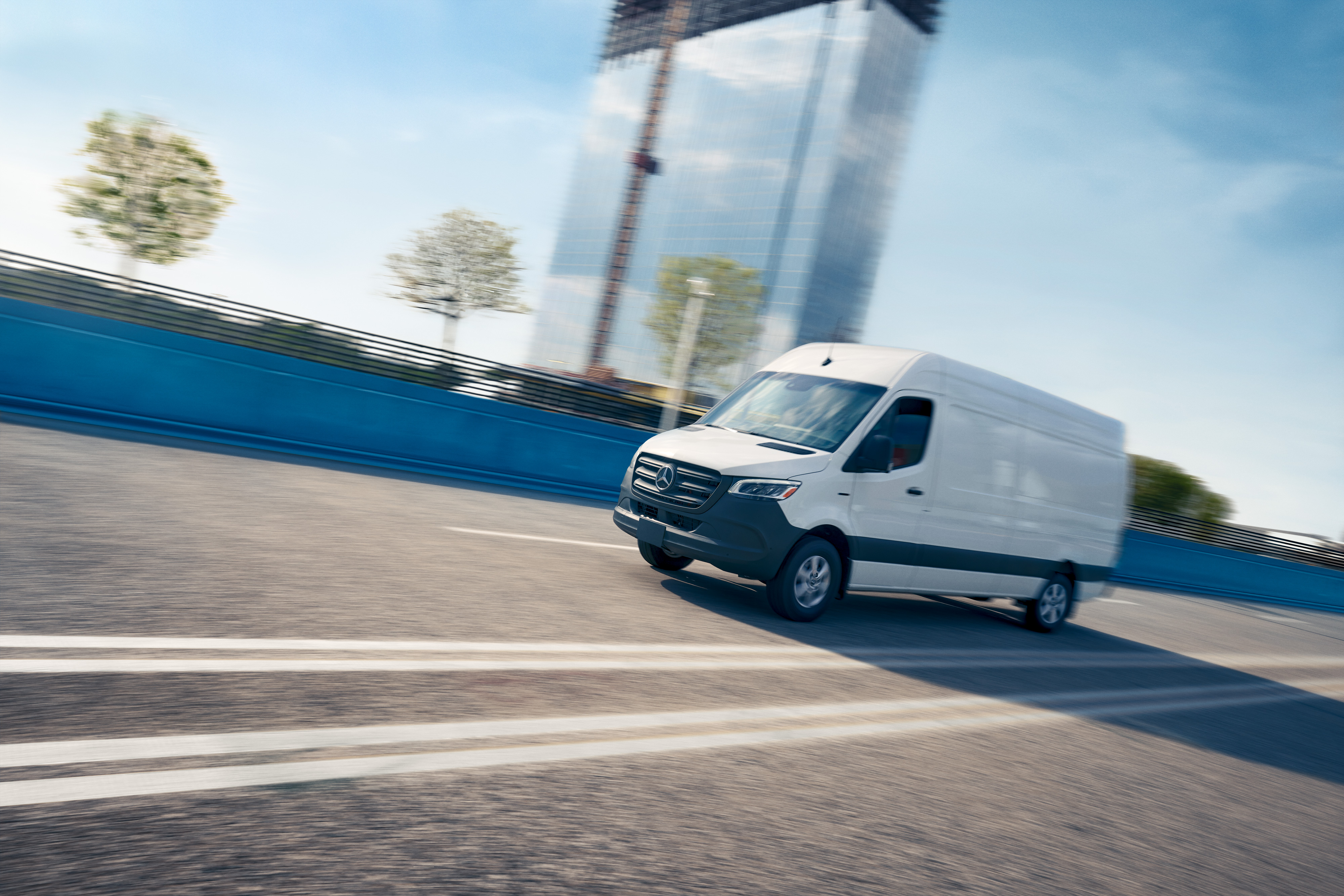 eSprinter Panel Van on the Road | Mercedes-Benz Vans A white Mercedes-Benz eSprinter Panel Van driving on the road.