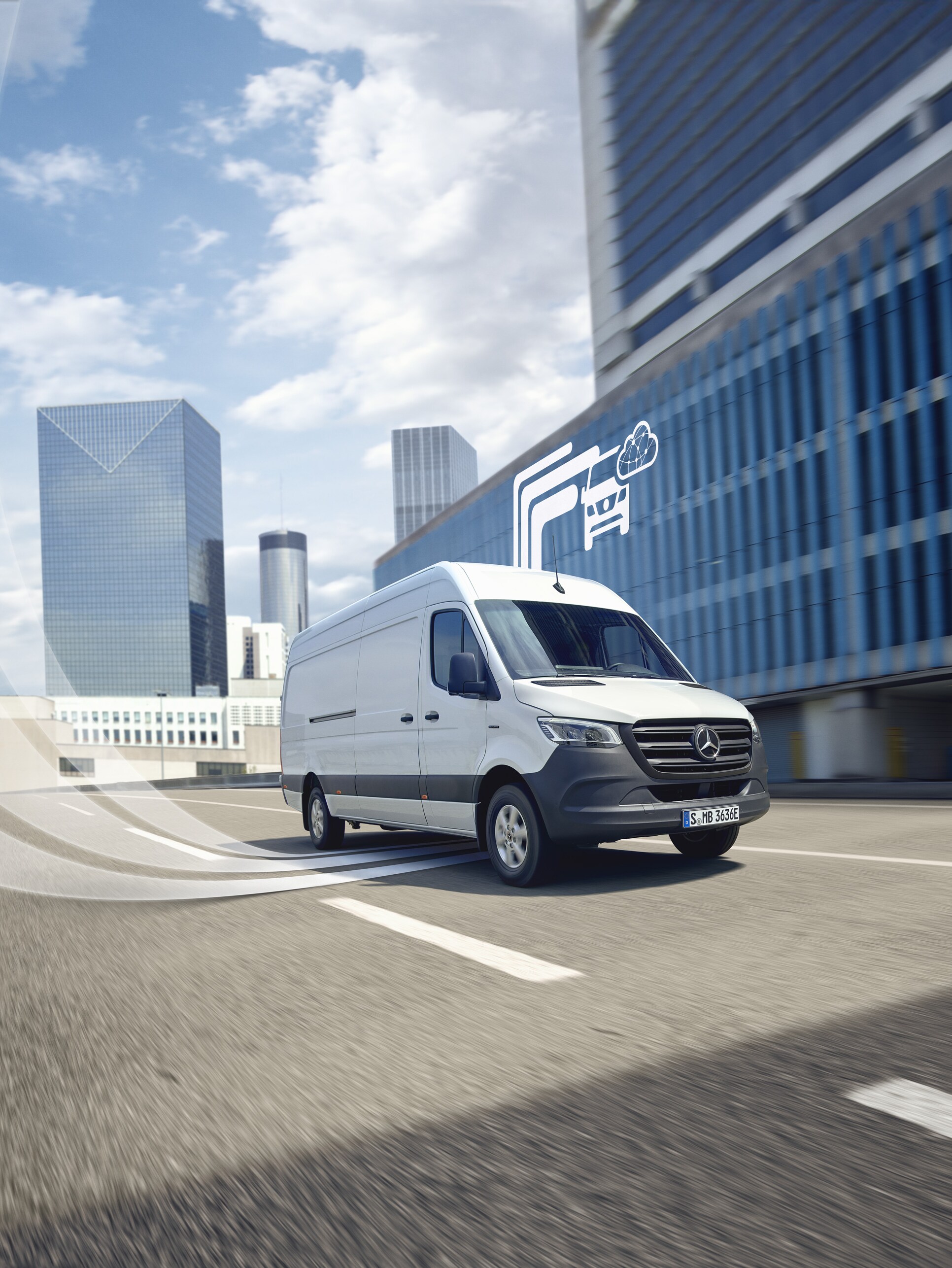 Mercedes-Benz van driving against a modern backdrop, digital mercedes benz technology is visualised.
