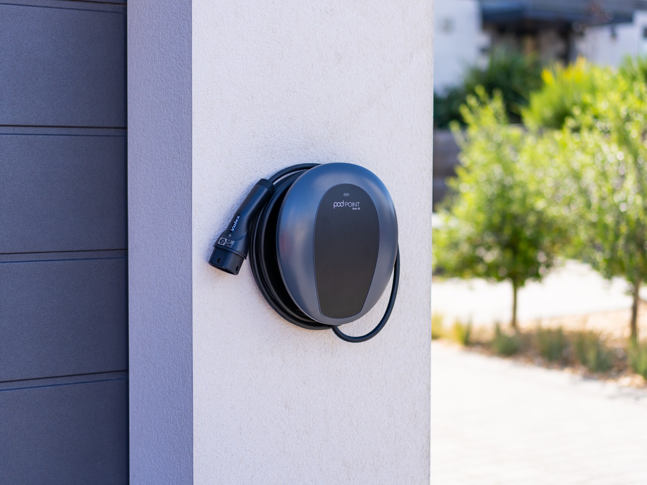 EV charging wall box on wood panel wall