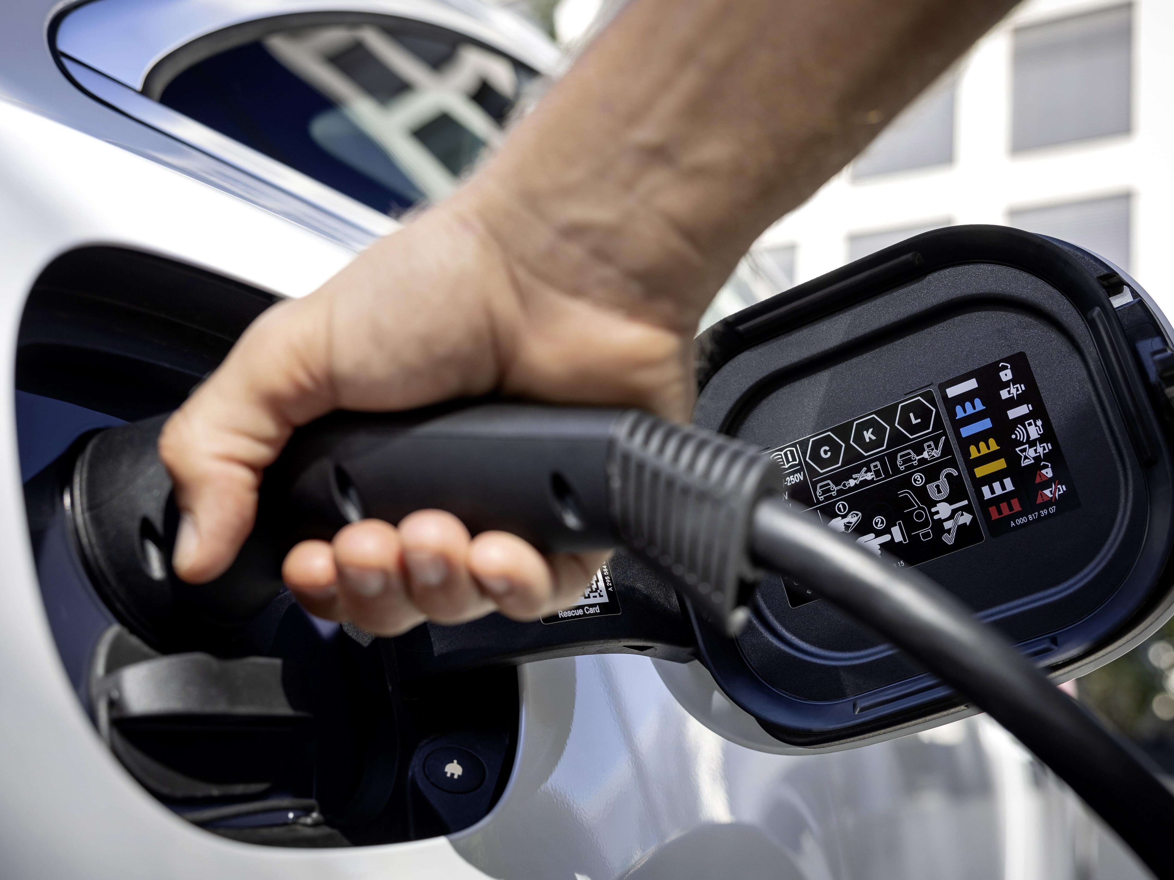 Image of person plugging in EV charger